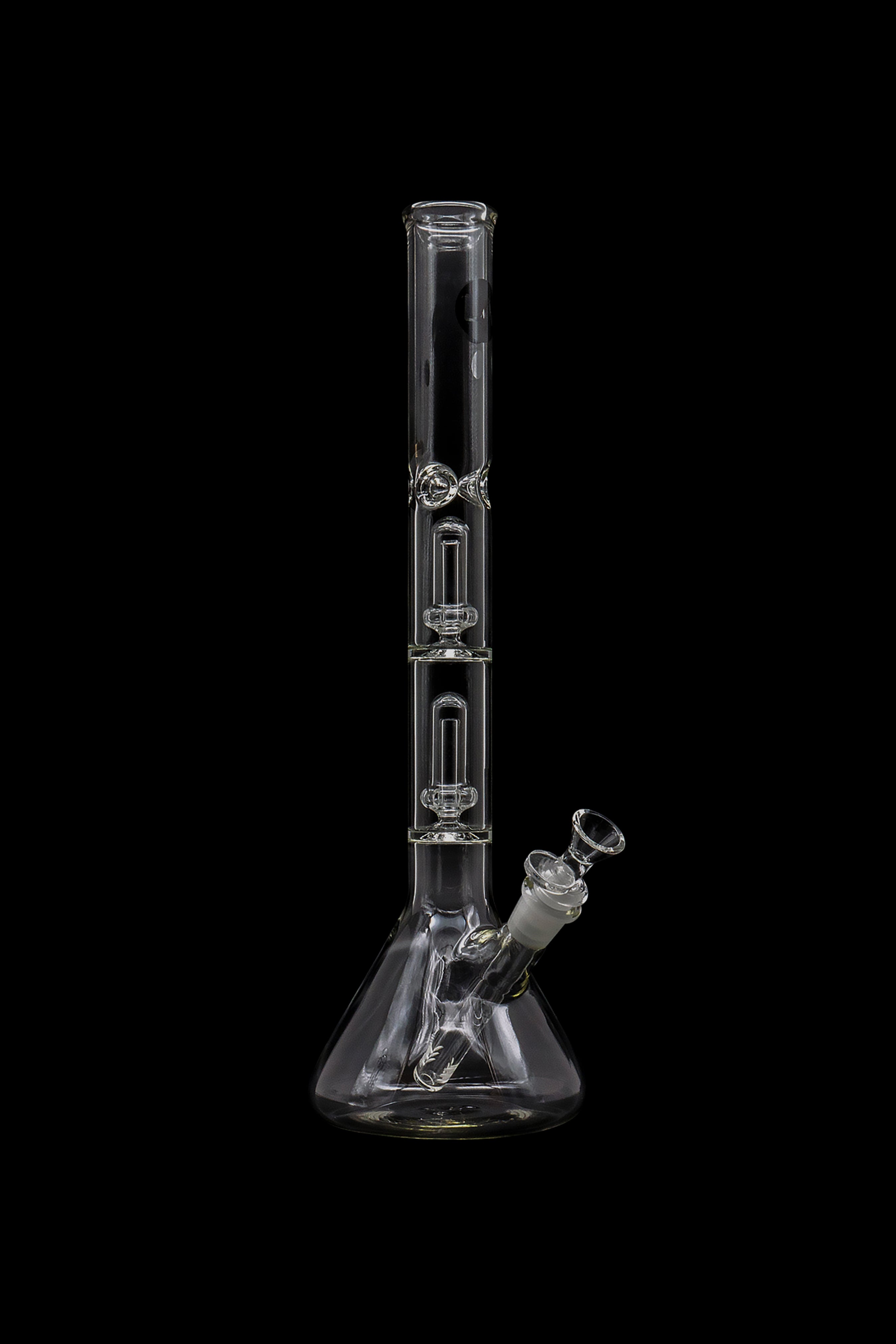 Clear glass bong with multiple perc filtration chambers, isolated on a black background.