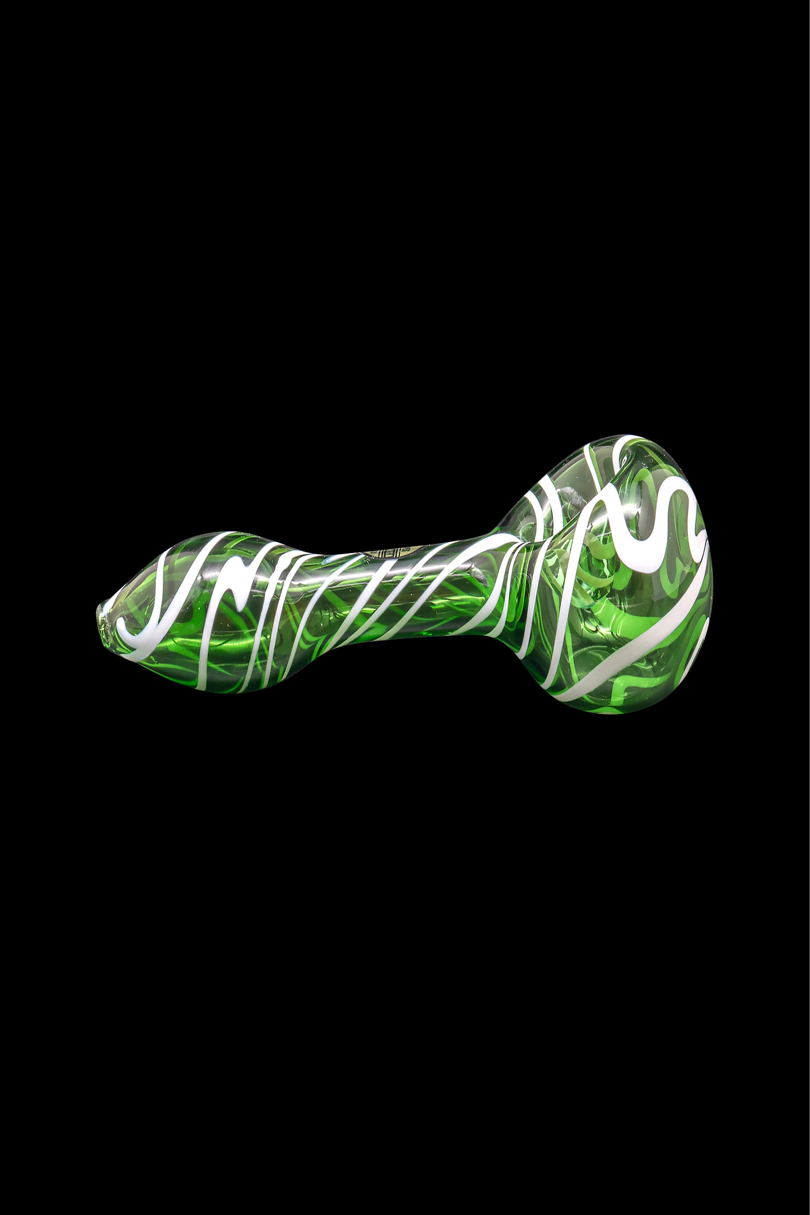 Green and white glass smoking pipe isolated on a black background.