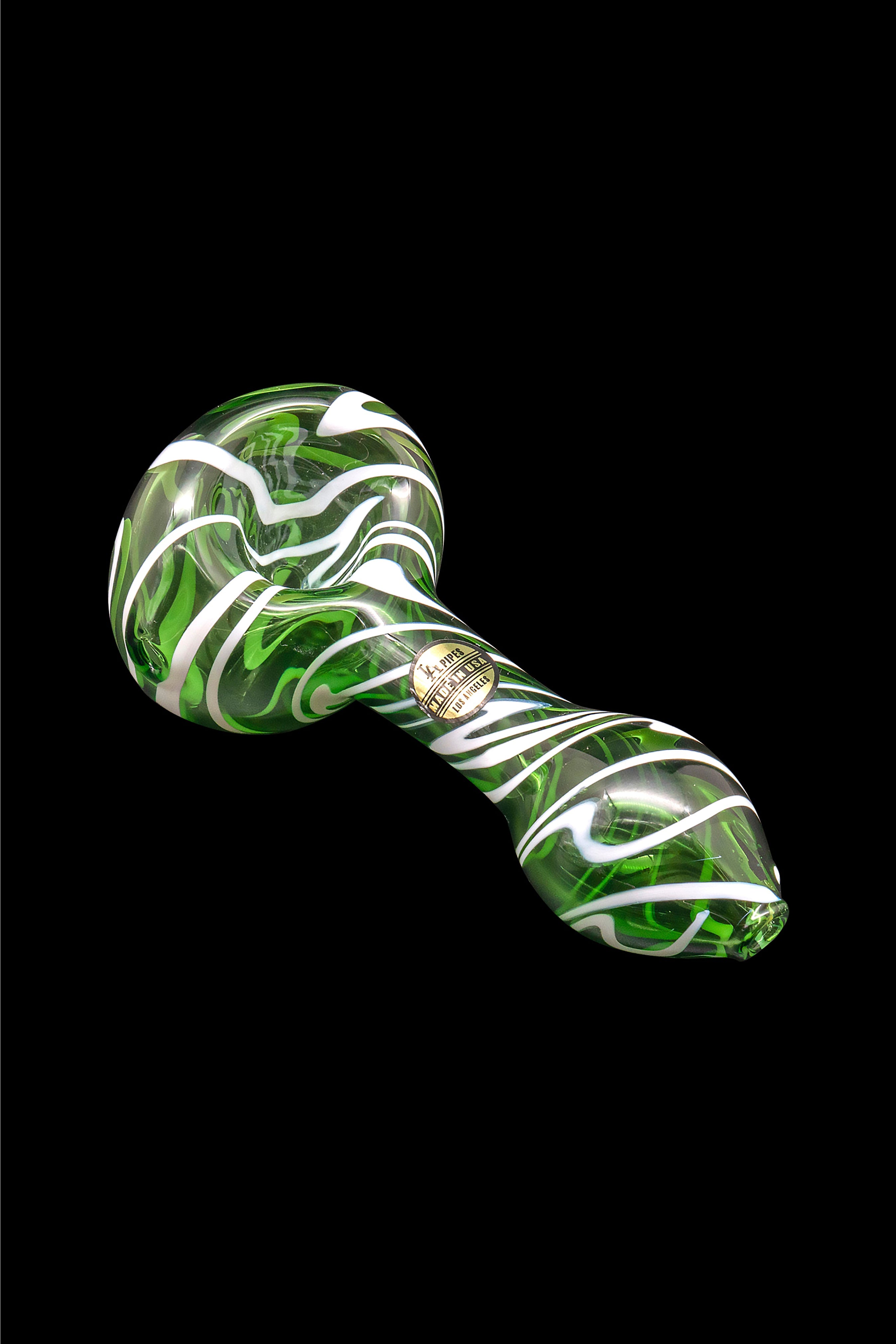 Green and white glass cannabis pipe isolated on a black background.