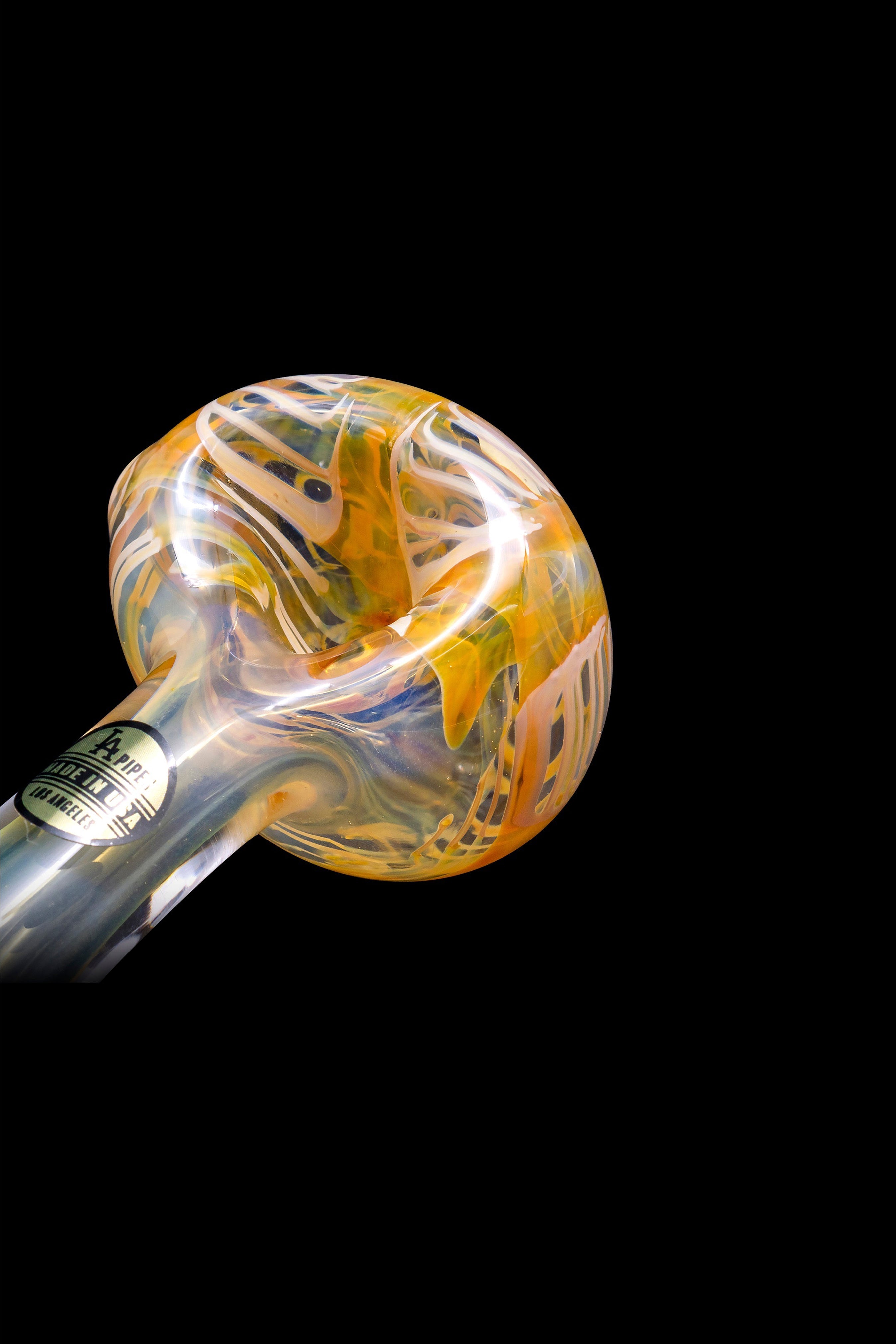 Hand-blown glass pipe with orange and cream swirls against a black background.