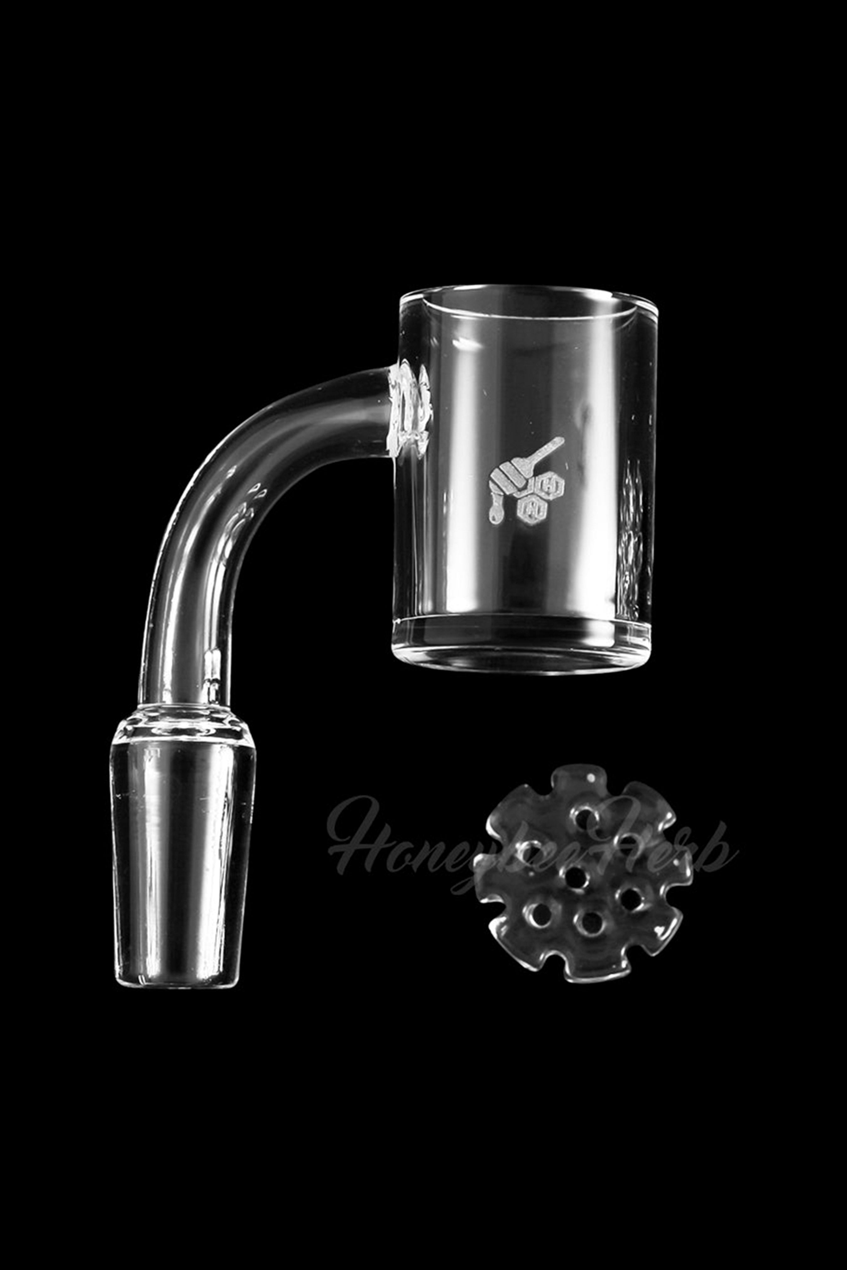 Clear glass dab rig components, including a bent neck and quartz banger, isolated on a black background.