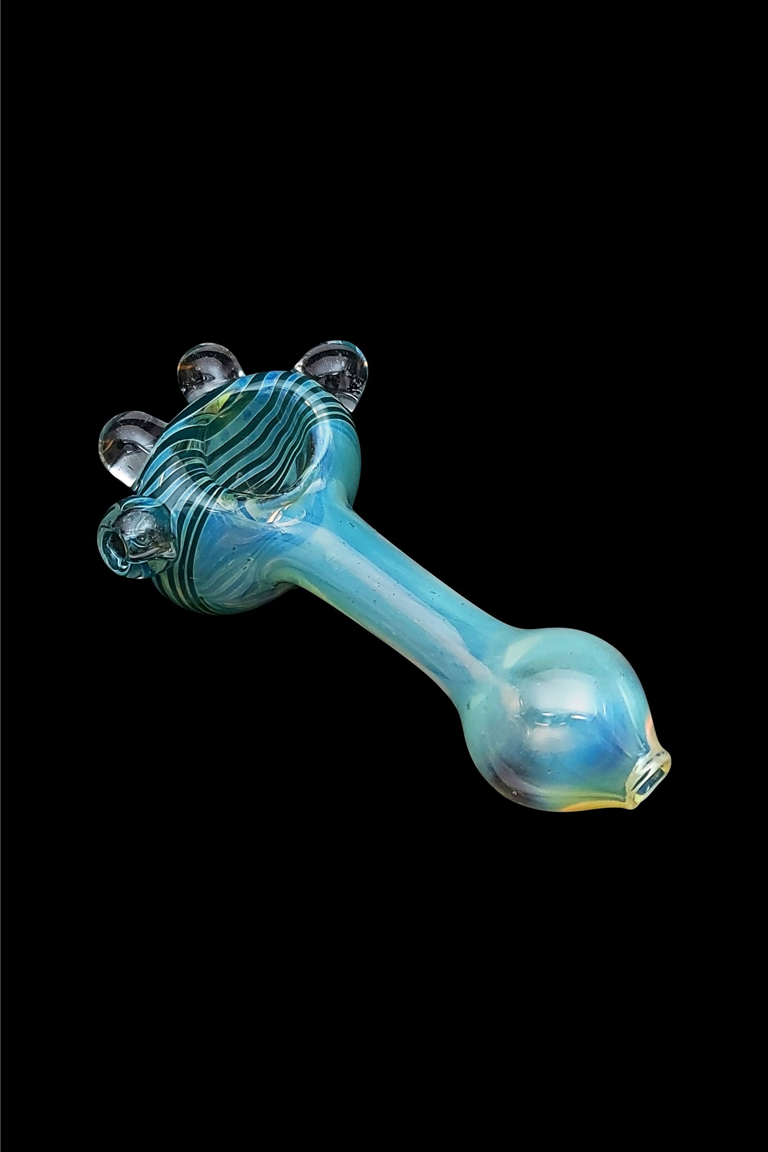 Hand-blown glass pipe with blue and green swirls, isolated on a black background.