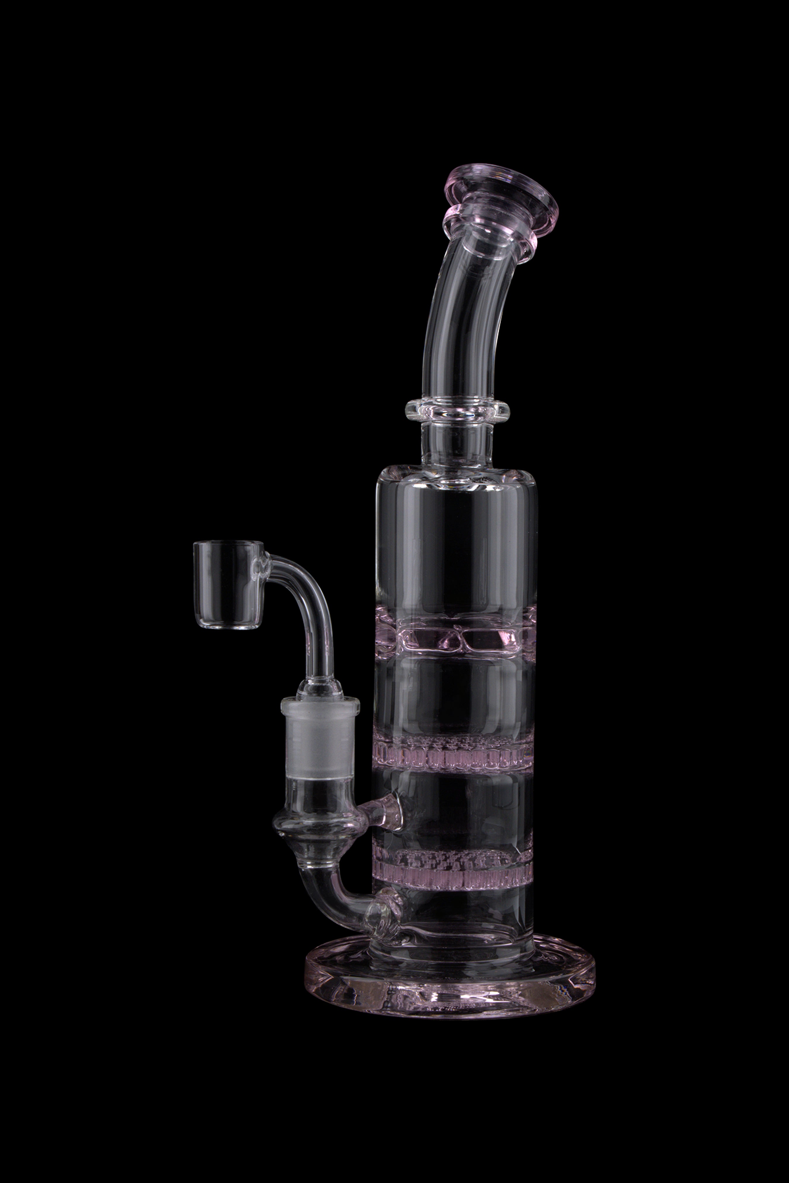 Studio shot of the Triple Honeycomb Dab Rig showing a vertical clear glass body with pink accents and a curved mouthpiece against a black background