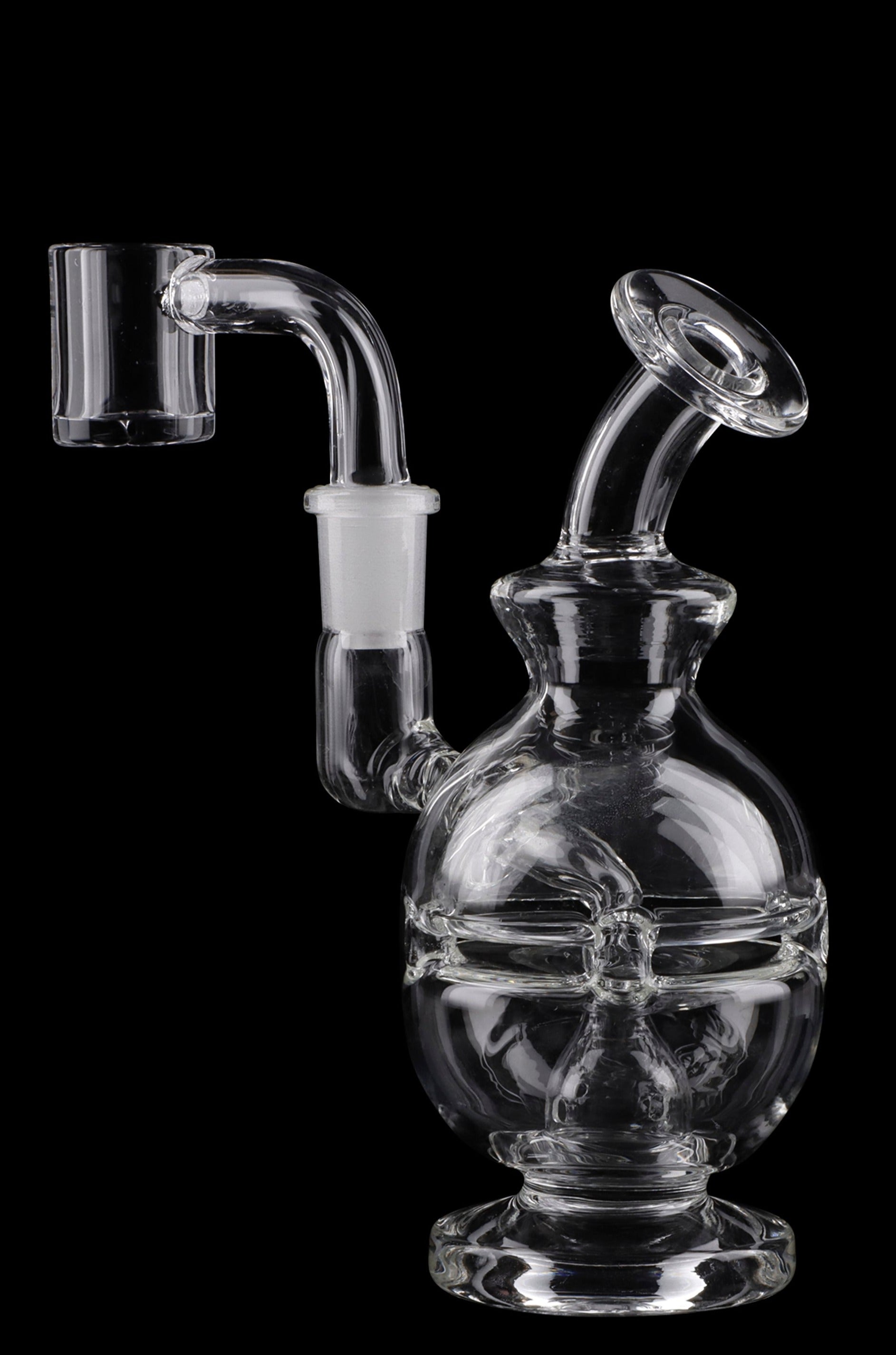 Clear glass water pipe (rig) with intricate design and accompanying glass piece, isolated on black.