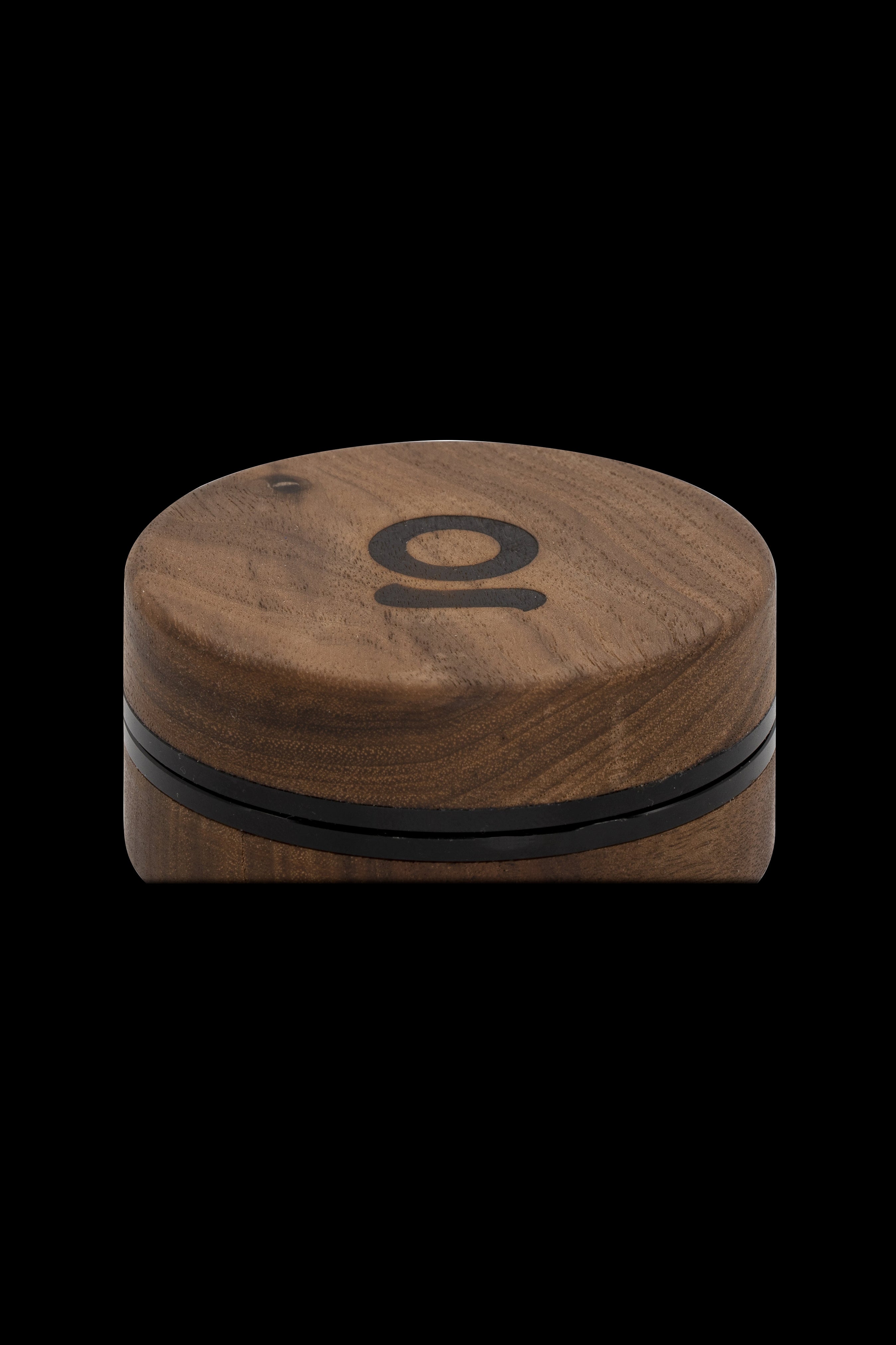 Wooden cannabis grinder with a black "O" logo.