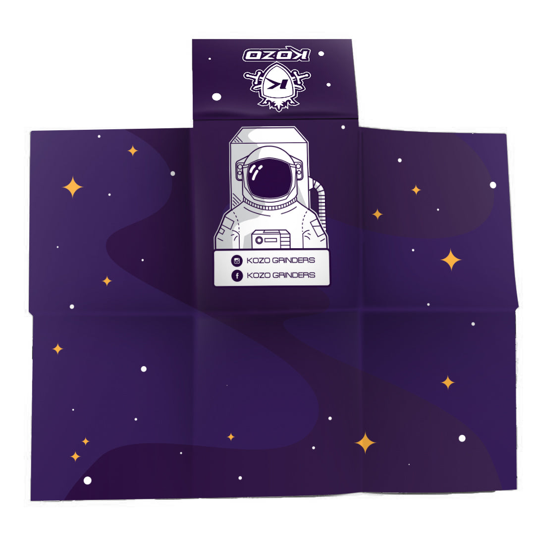 Navy blue cannabis accessory wrap featuring a white astronaut illustration and “Kozo Grinders” branding with scattered star graphics.
