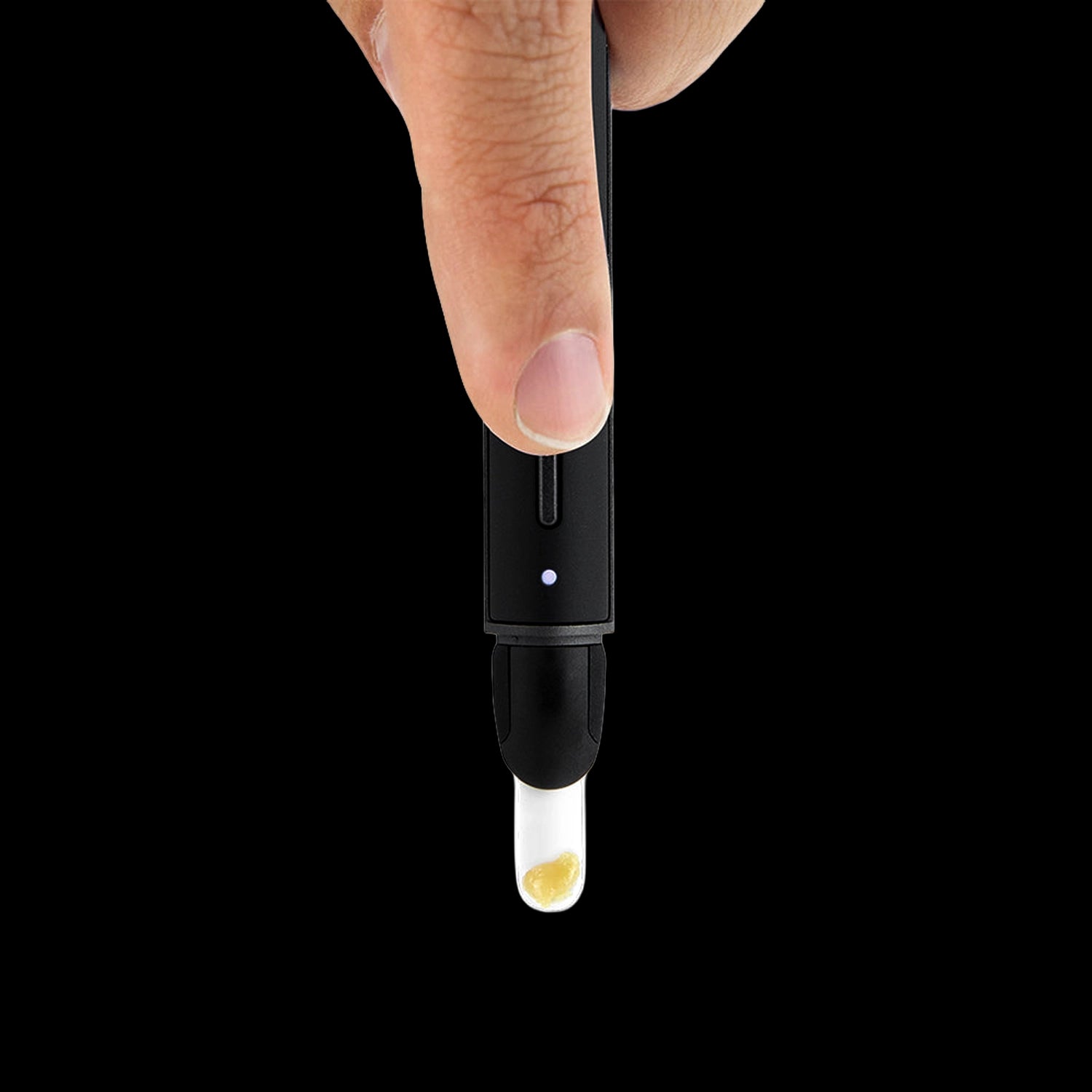 Close-up front view of a finger pressing the black Puffco New Hot Knife, its LED lit and a small dab visible on the glass tip against a black background.