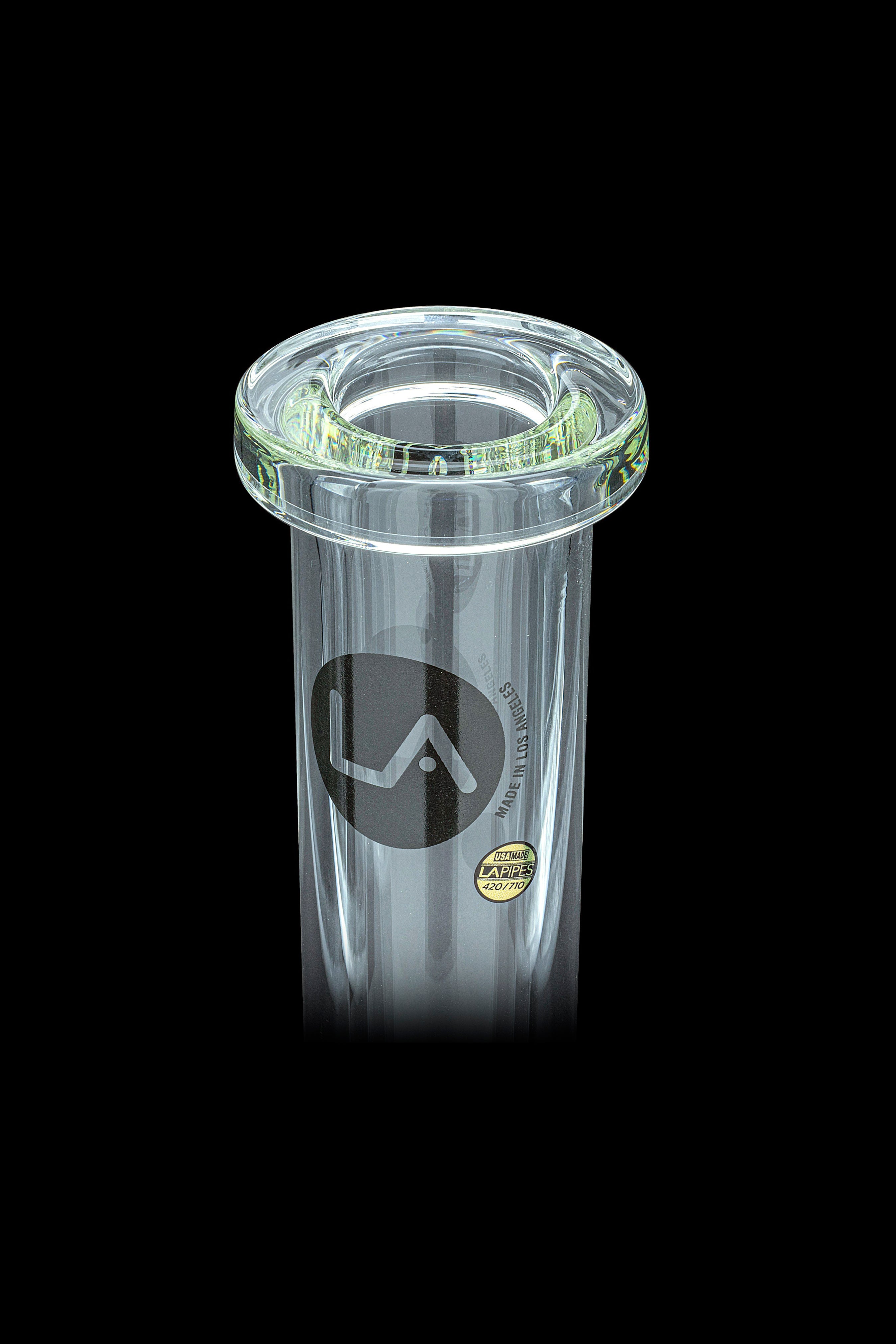 Clear glass ashtray with a green rim and “LA” logo, isolated on a black background.
