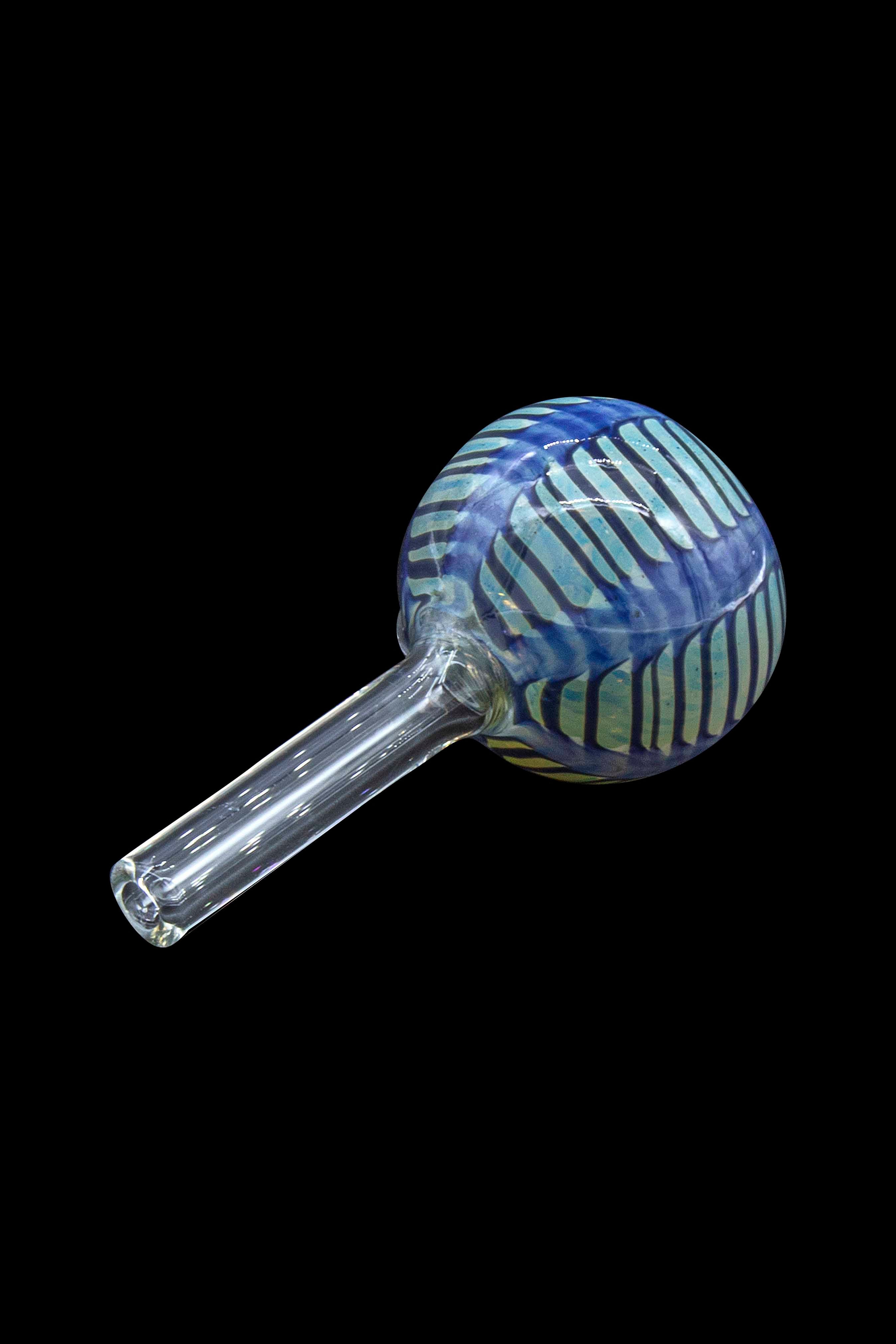 Glass cannabis oil burner pipe with blue and green swirls.