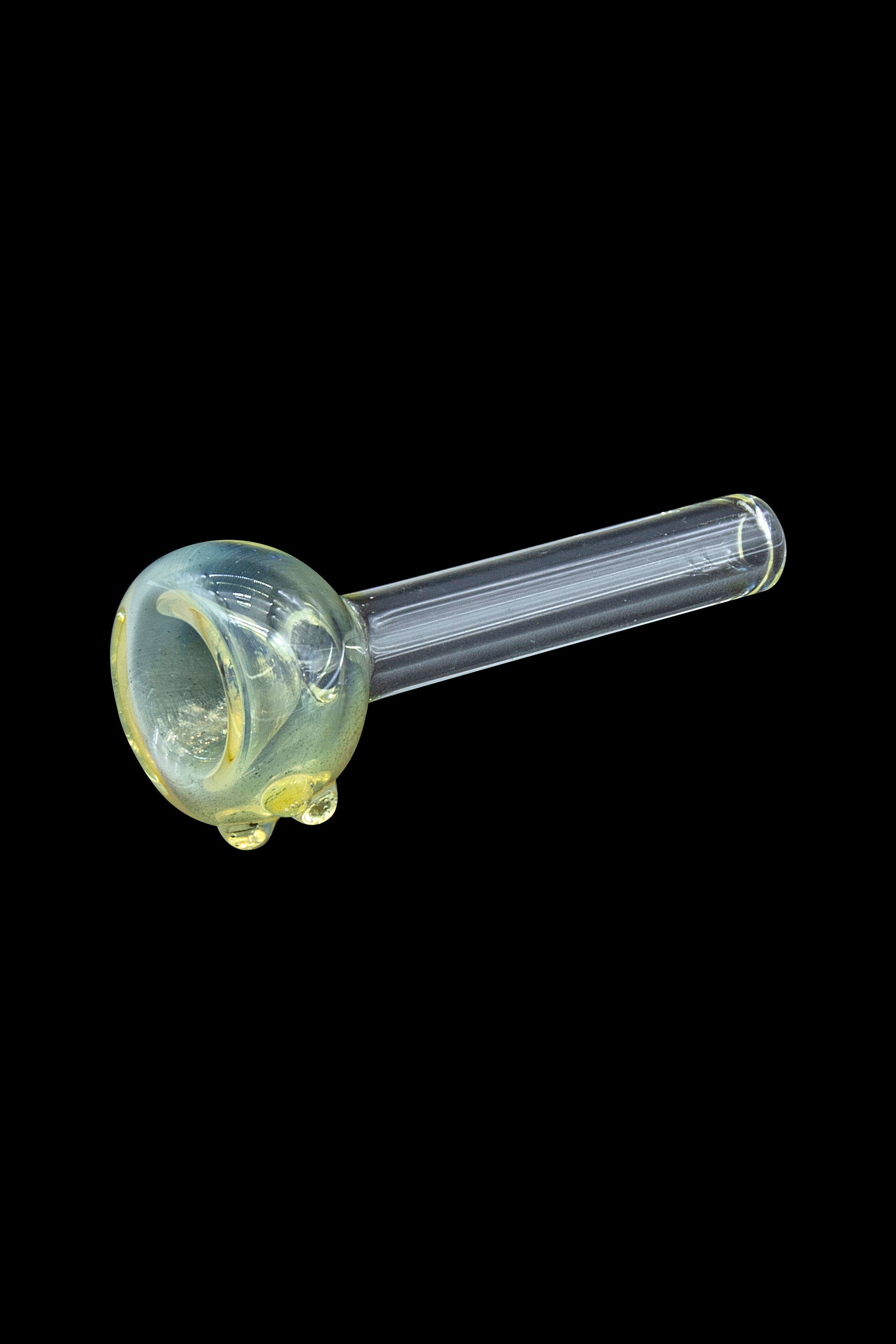 Green glass smoking pipe isolated on a black background.