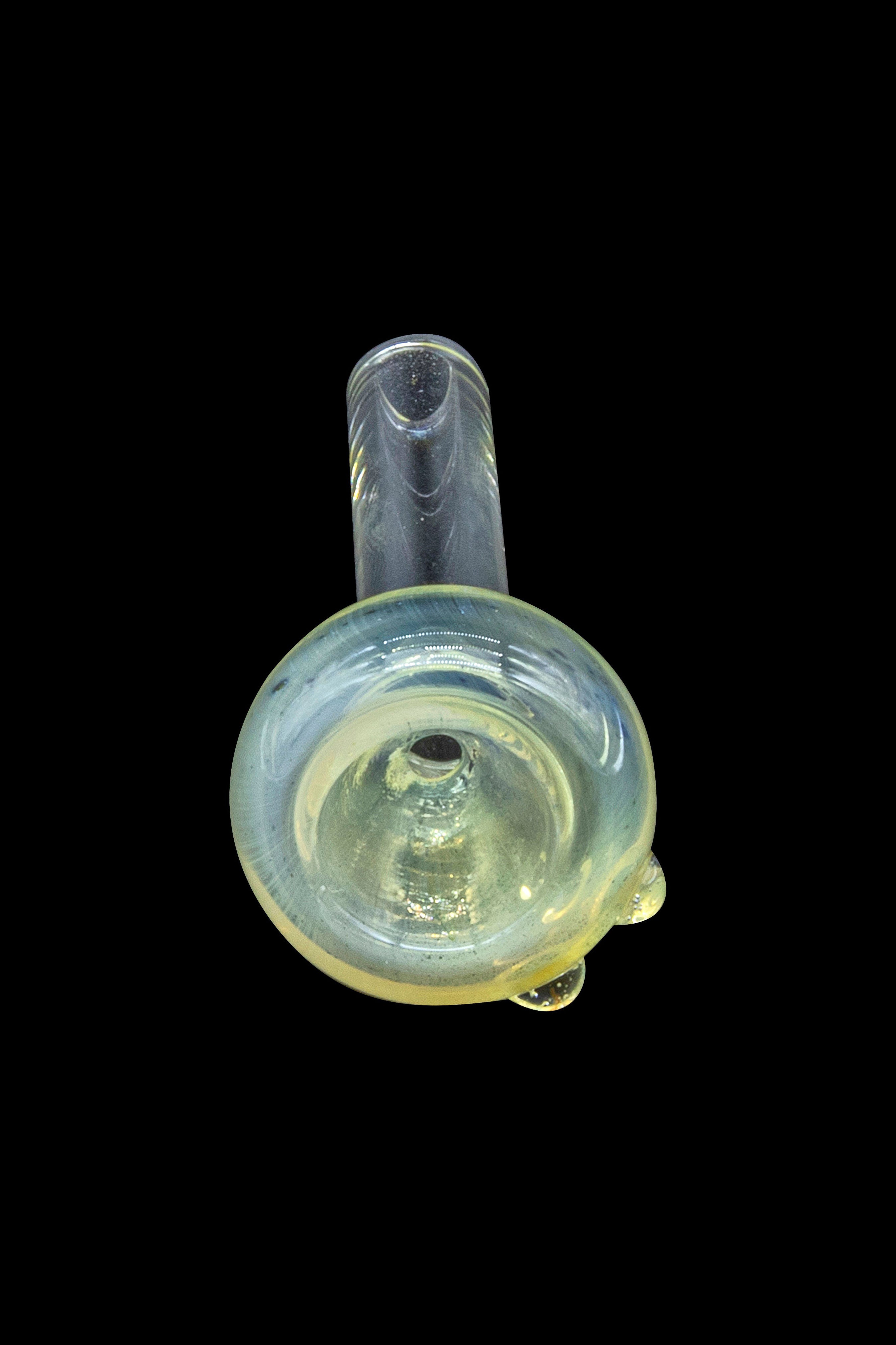 Glass bubbler pipe for smoking cannabis, isolated on a black background.