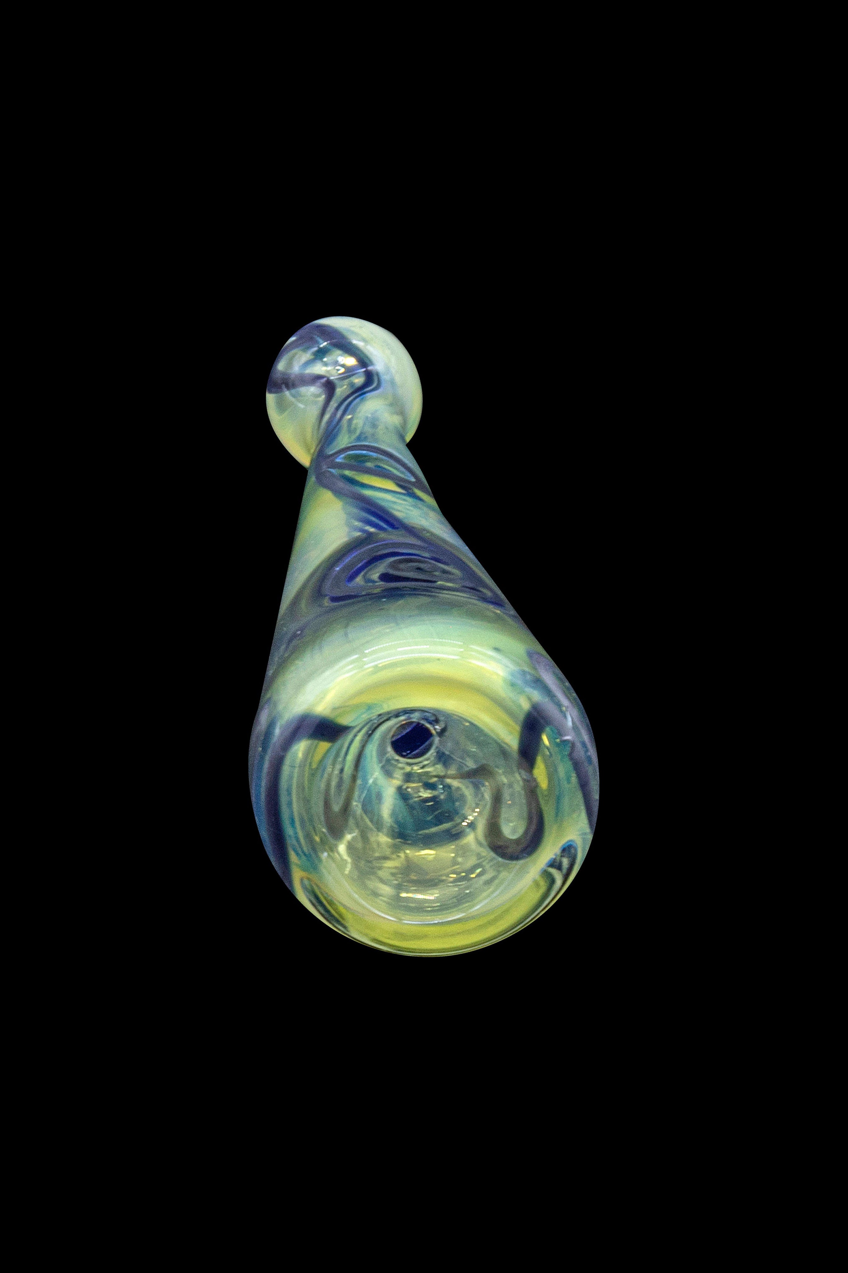 Green and purple glass cannabis pipe against a black background.
