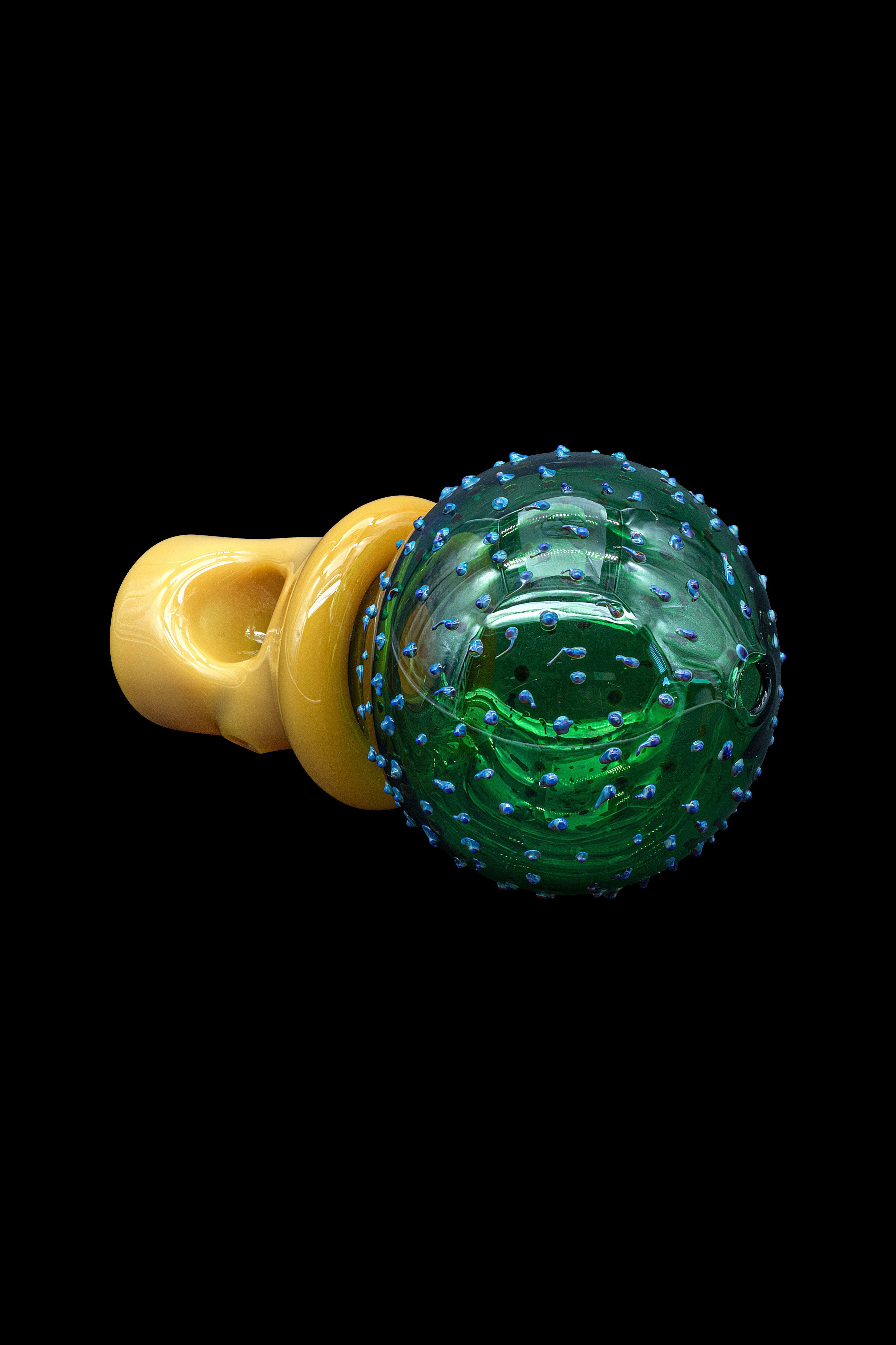 Hand-blown glass cannabis pipe with a textured green and blue bubbled sphere and amber mouthpiece.
