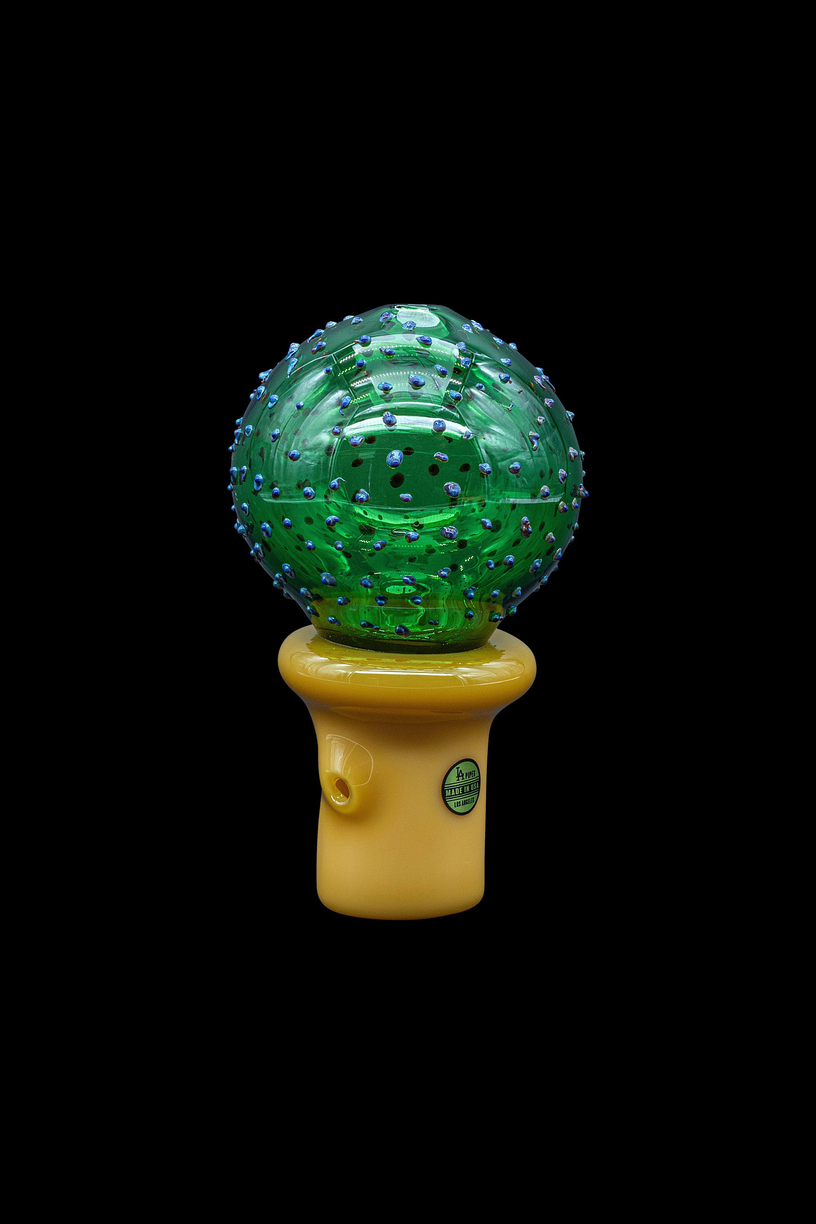 Green glass cannabis water pipe with a spherical, textured bubbler and yellow mouthpiece.
