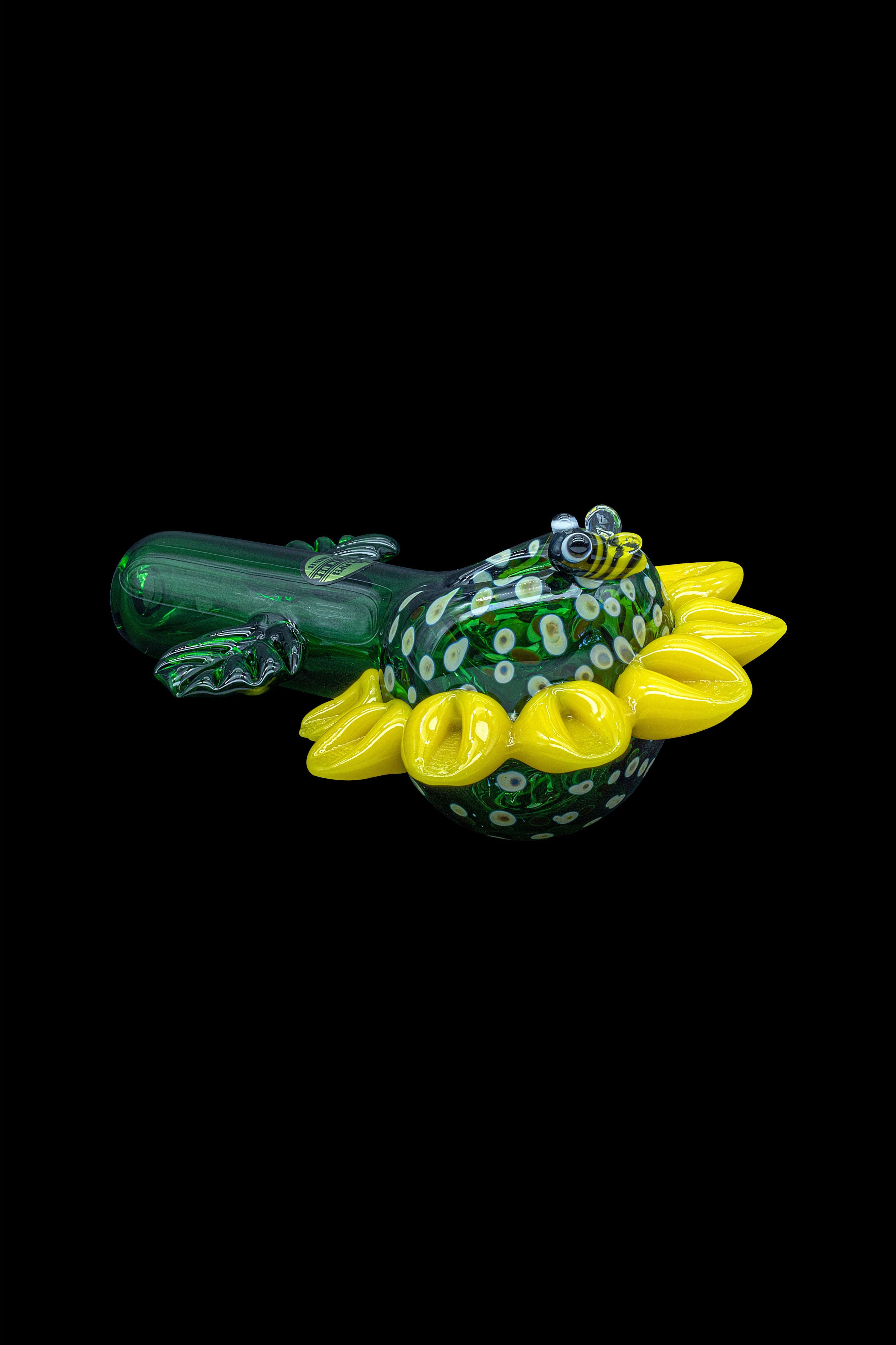 Hand-blown glass frog with yellow floral accents, likely a cannabis smoking piece.