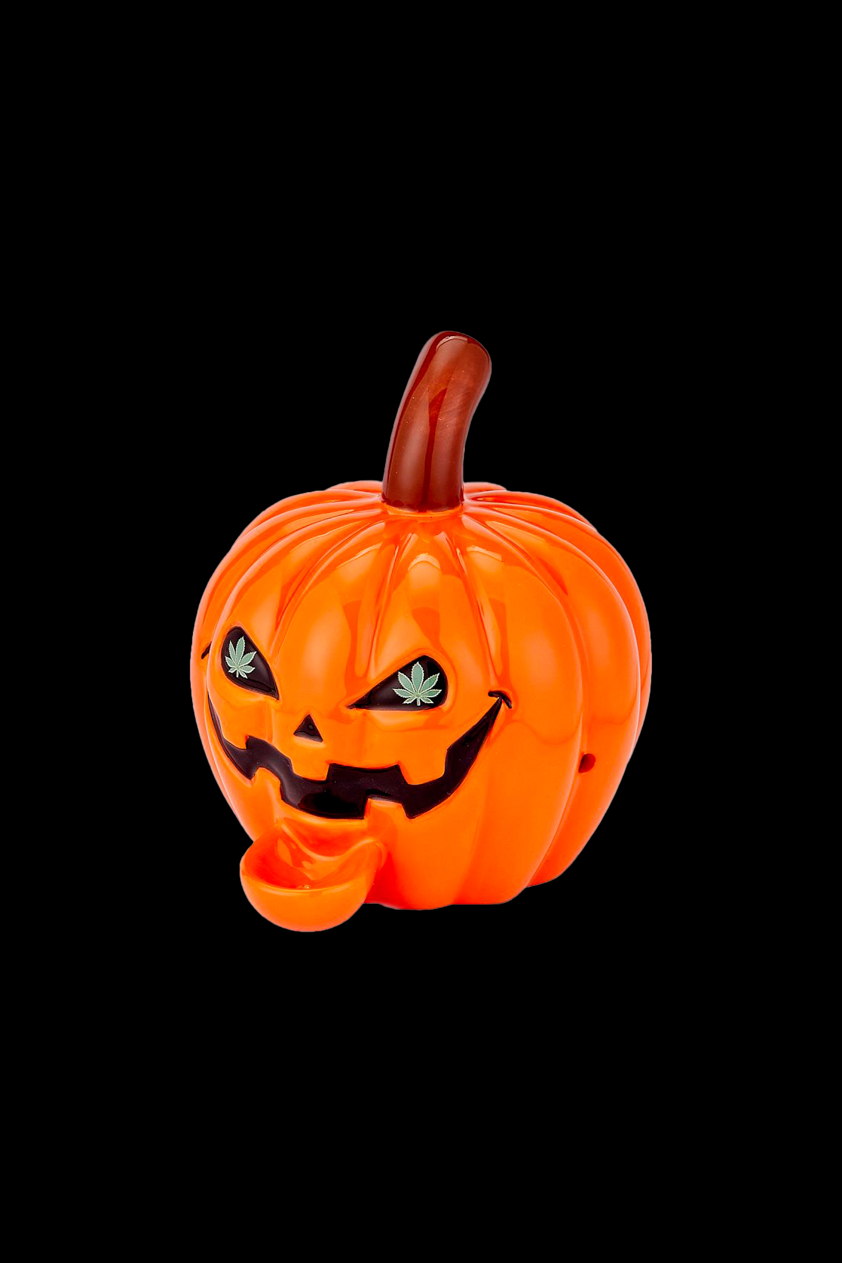 Orange jack-o'-lantern water pipe with cannabis leaf eyes against a black background.