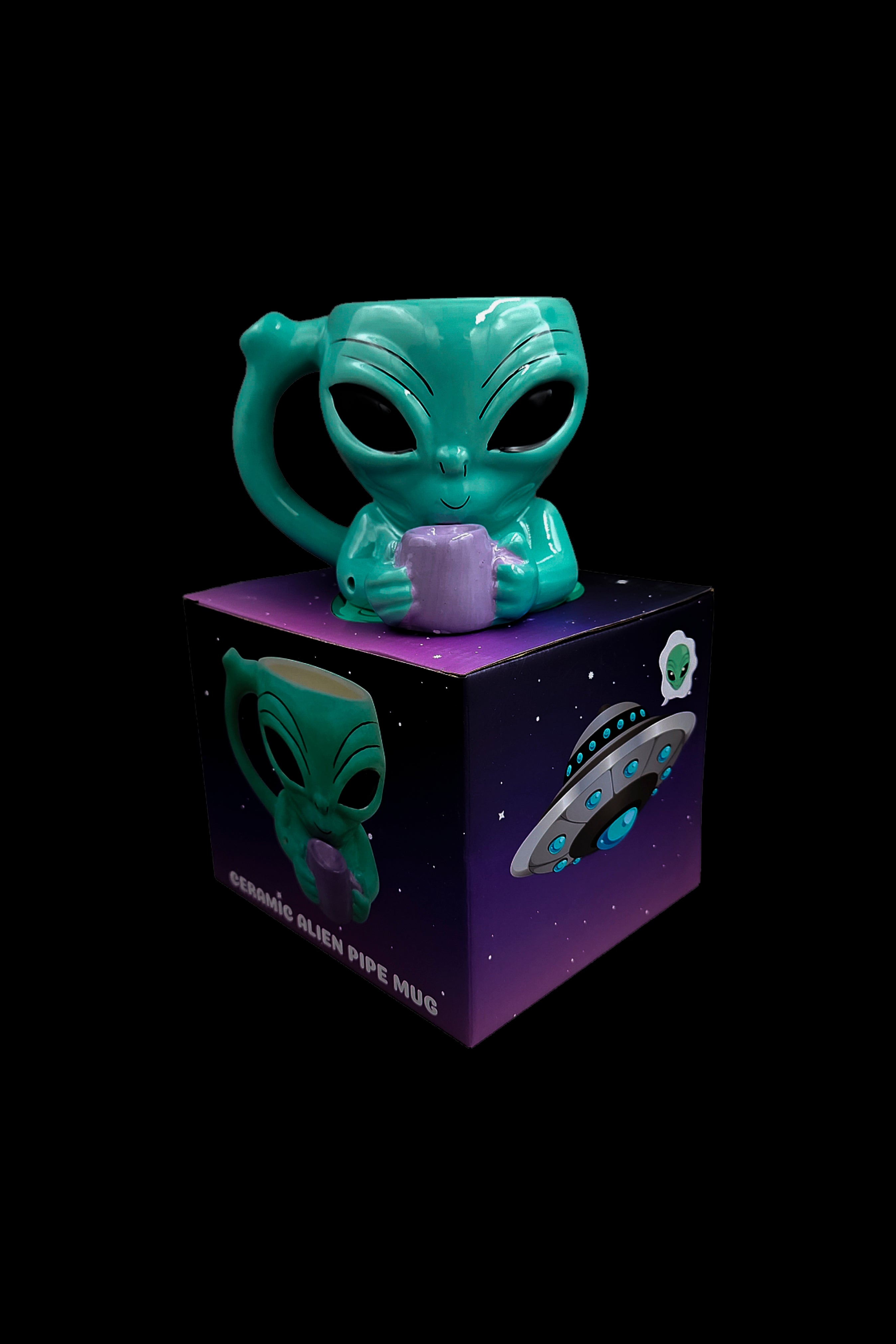 Ceramic alien-shaped pipe mug displayed on its branded box, against a black background.