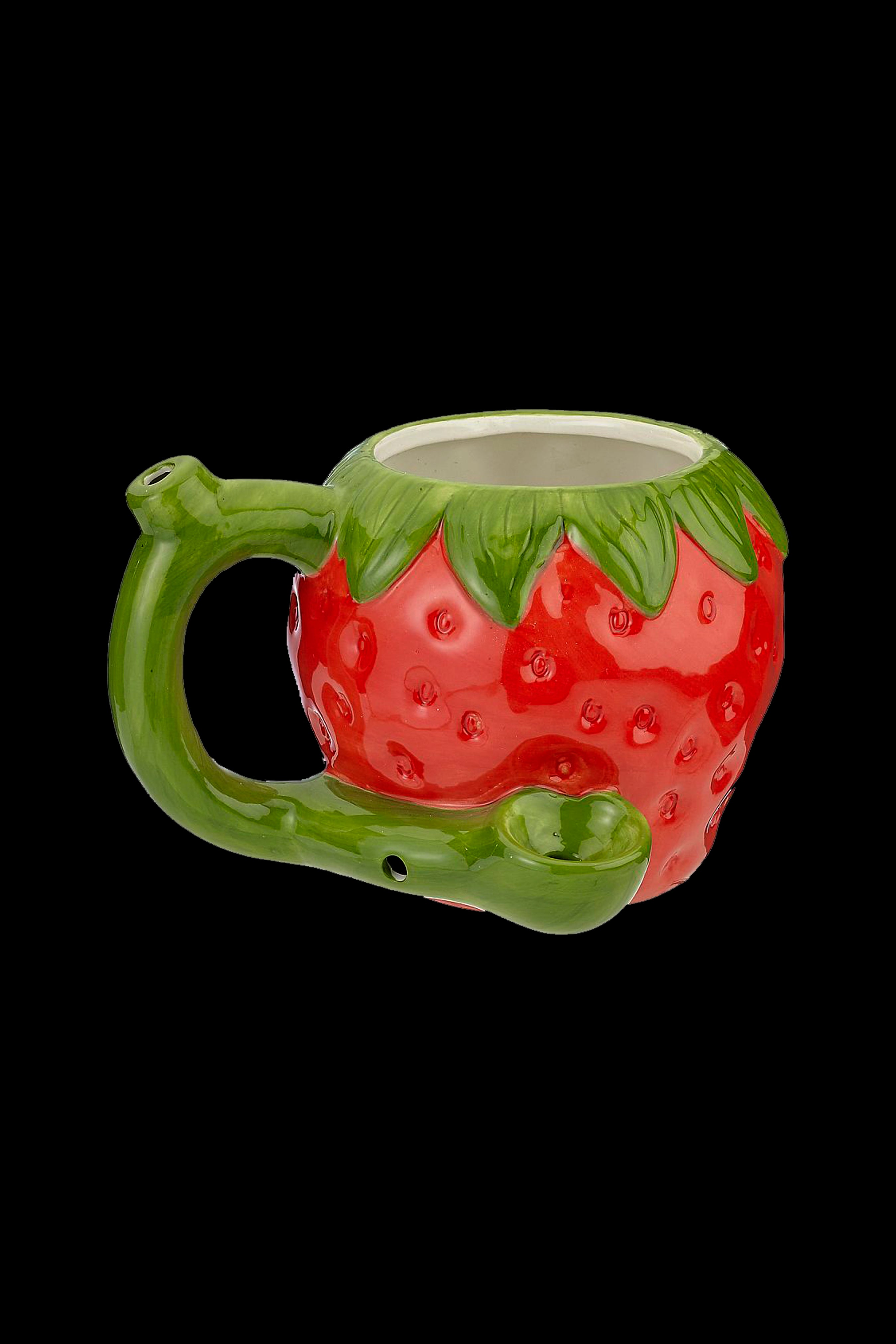 Red strawberry-shaped glass pipe with a green handle and leaves, isolated on a black background.