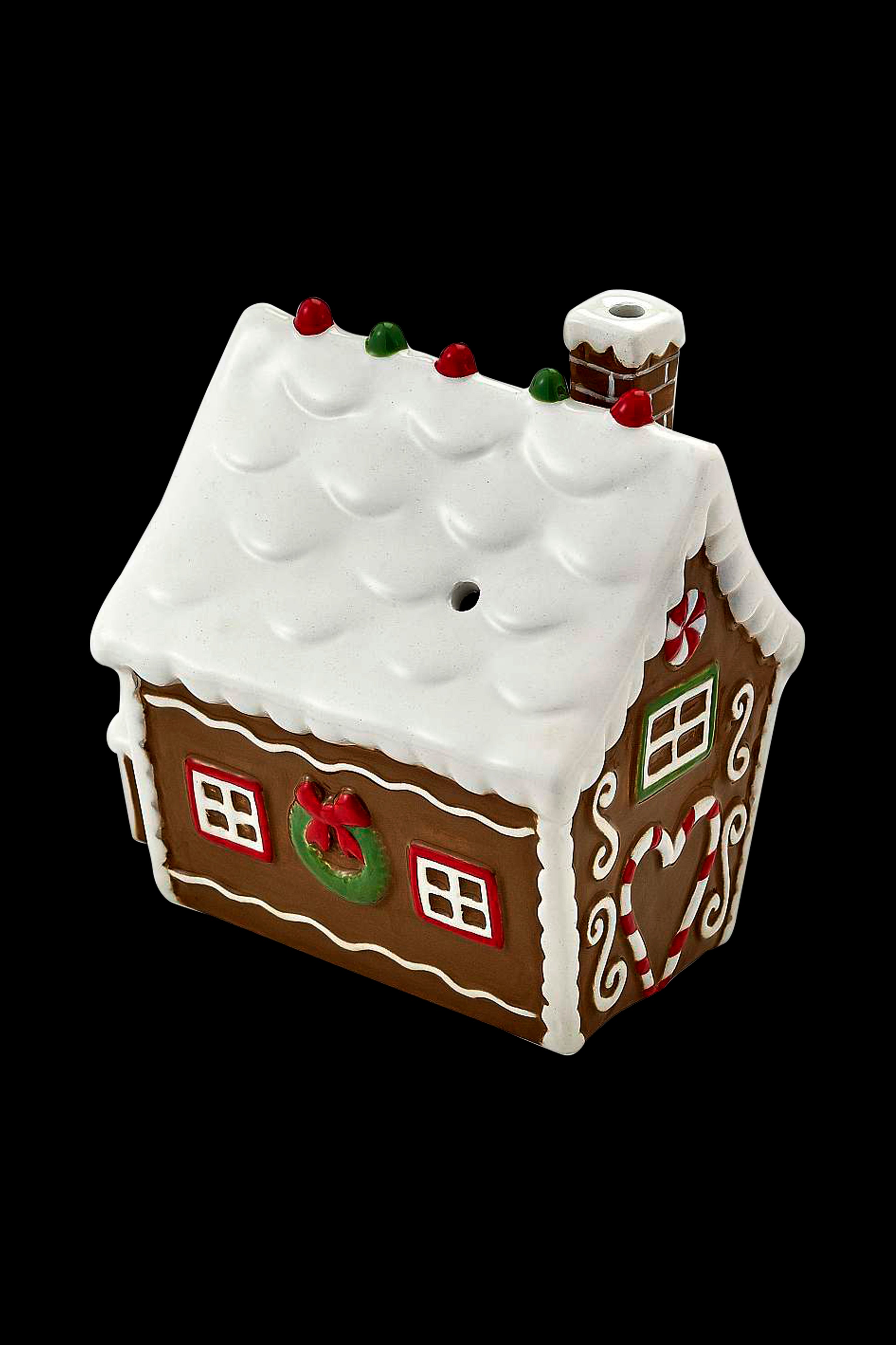Gingerbread house-shaped cannabis pipe with white icing details and a chimney.