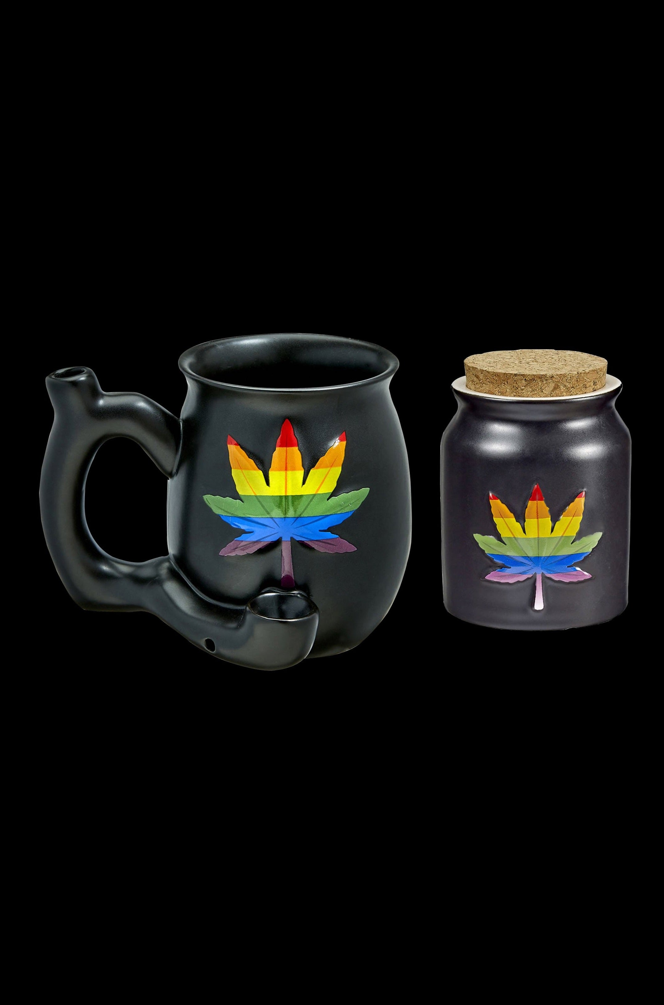 Black cannabis smoking pipe shaped like a mug and a matching storage jar with rainbow leaf designs, isolated on a black background.