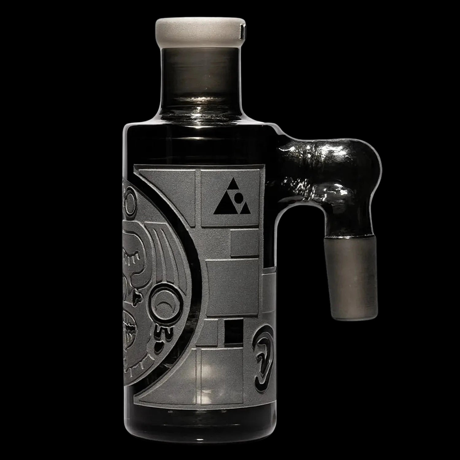 Close-up, three-quarter view of the clear Milkyway Maya Wet Ash Catcher showing a frosted joint, side handle, and engraved circular designs against a black background.