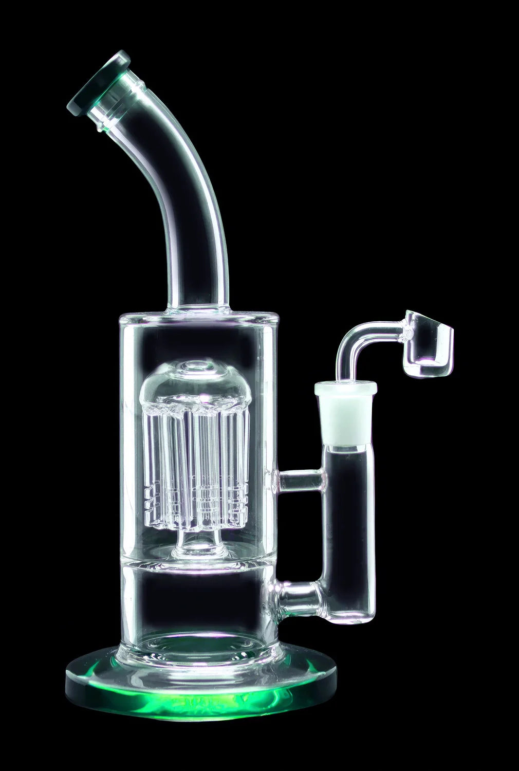 Glass water pipe with intricate percolator and quartz nail, illuminated with green light.