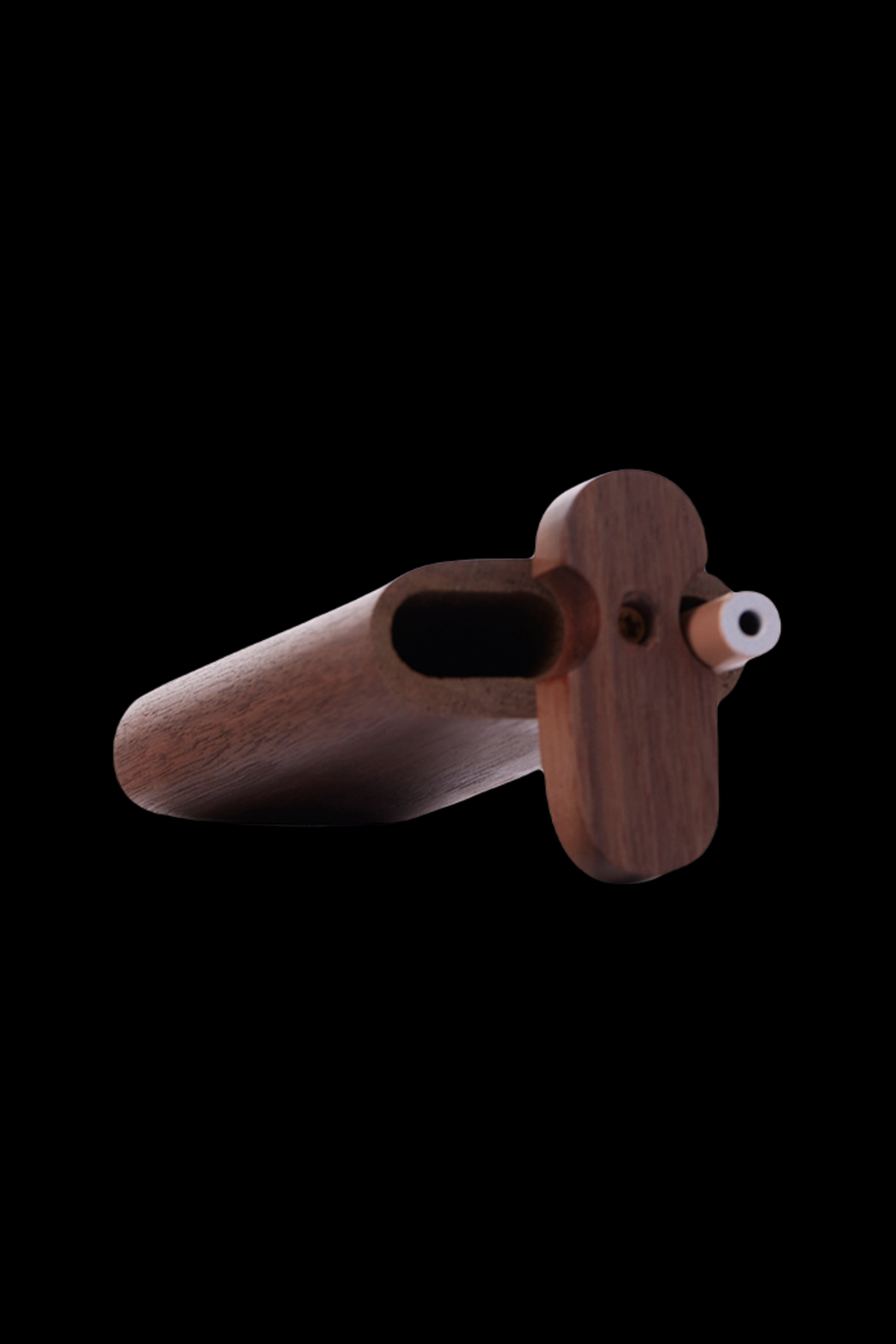 Wooden cannabis pipe with a rounded bowl and carved handle, isolated on a black background.