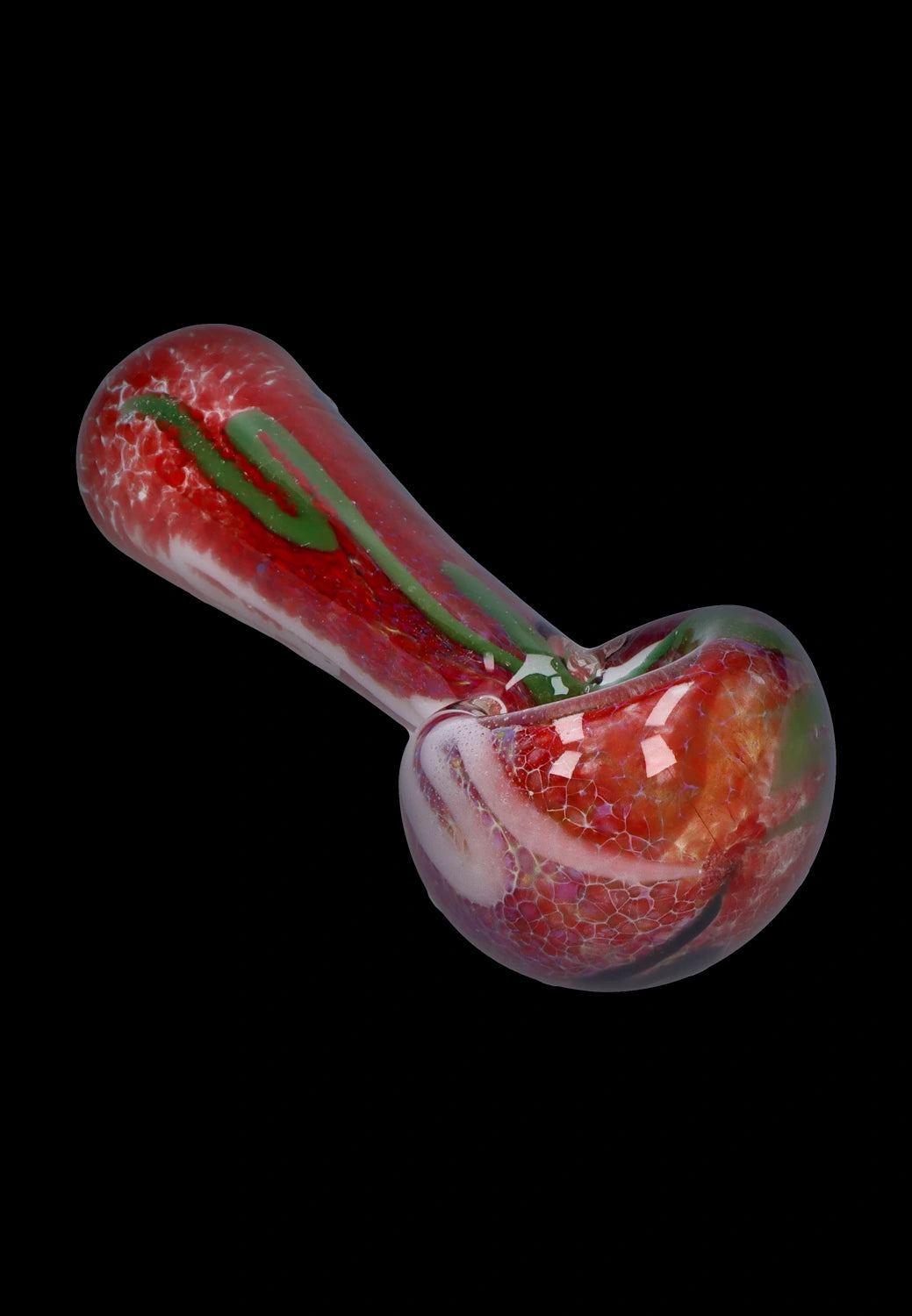Angled close-up of the Smoke Cartel Color Frit Spoon Pipe - 3 in., showing its glossy red frit texture with green ribbon detail against a black background.