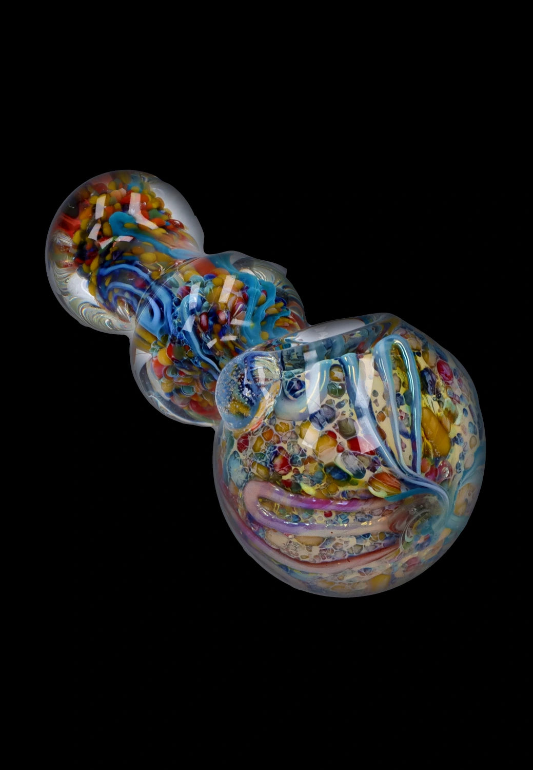 Angled close-up of the Smoke Cartel Fancy Frit Spoon Pipe - 3.5 in. showing swirling multicolored frit patterns under clear glass on a black background
