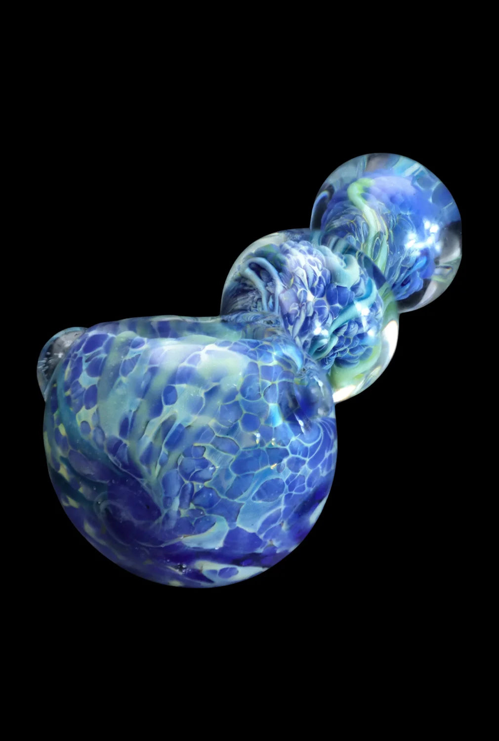 Angled close-up of the Smoke Cartel Fancy Frit Spoon Pipe - 3.5 in. showing swirling blue and green frit patterns against a black background.