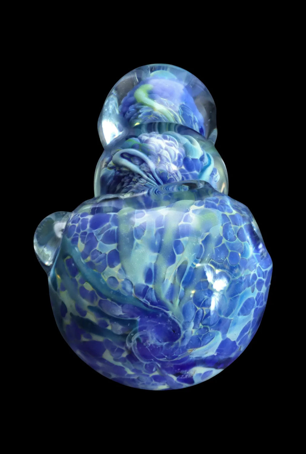 Top-down view of the Smoke Cartel Fancy Frit Spoon Pipe - 3.5 in. showing swirling blue, teal, and white frit patterns under glossy clear glass against a black background