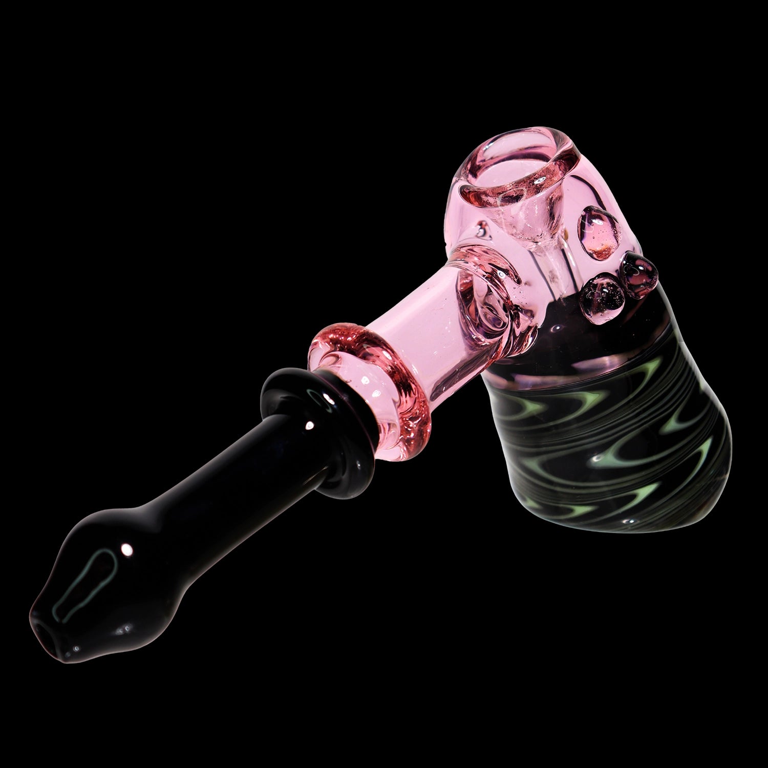 Angled close-up of the Smoke Cartel Black & Pink Swirl Hammer - 8 in., showing a pink glass joint and black handle against a black background