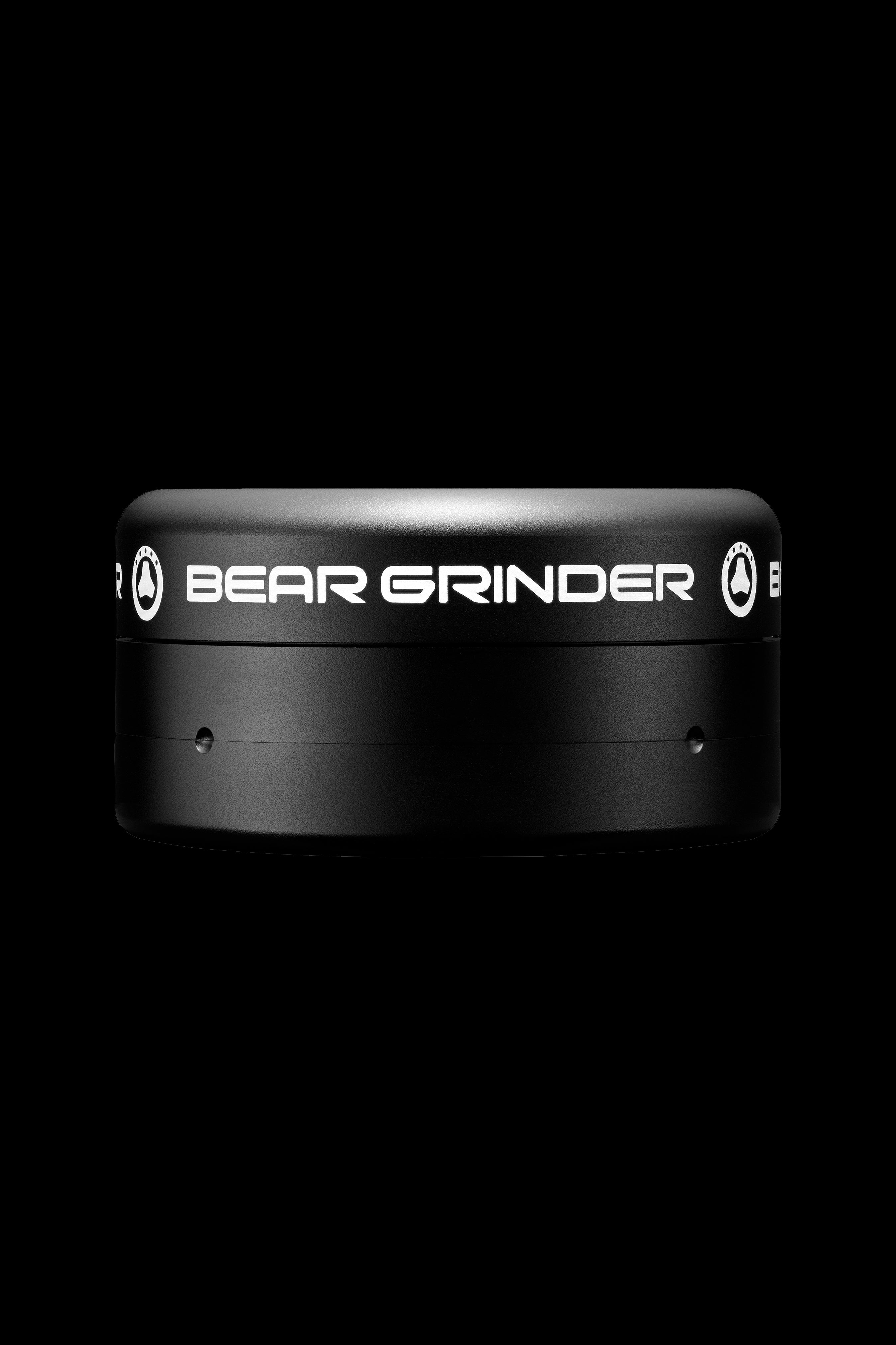 Black cannabis grinder with "BEAR GRINDER" text.