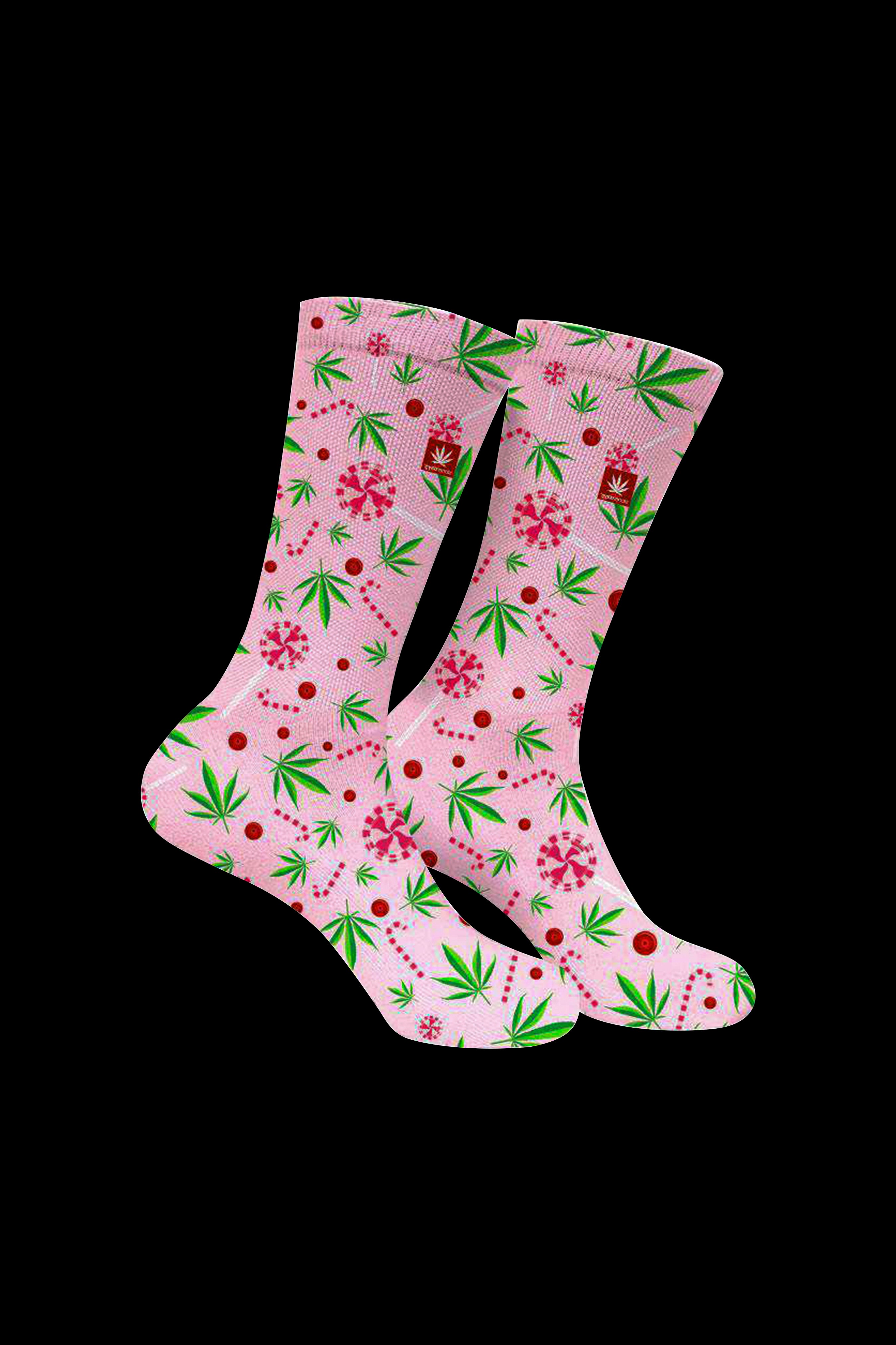 Pink crew socks with a pattern of cannabis leaves and red berries against a white background.