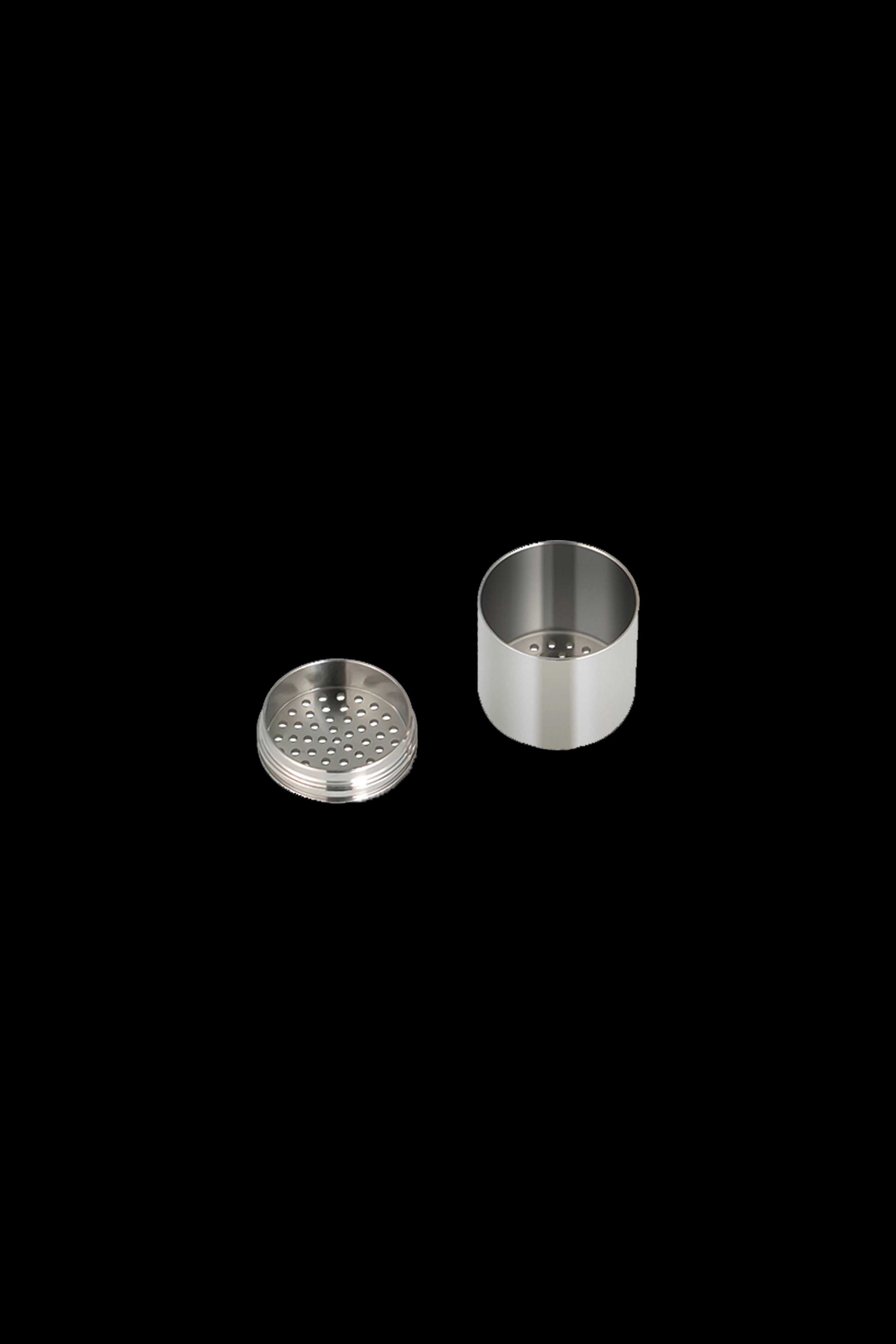 Silver metal grinder components separated, showing a perforated grinding plate and cylindrical base.