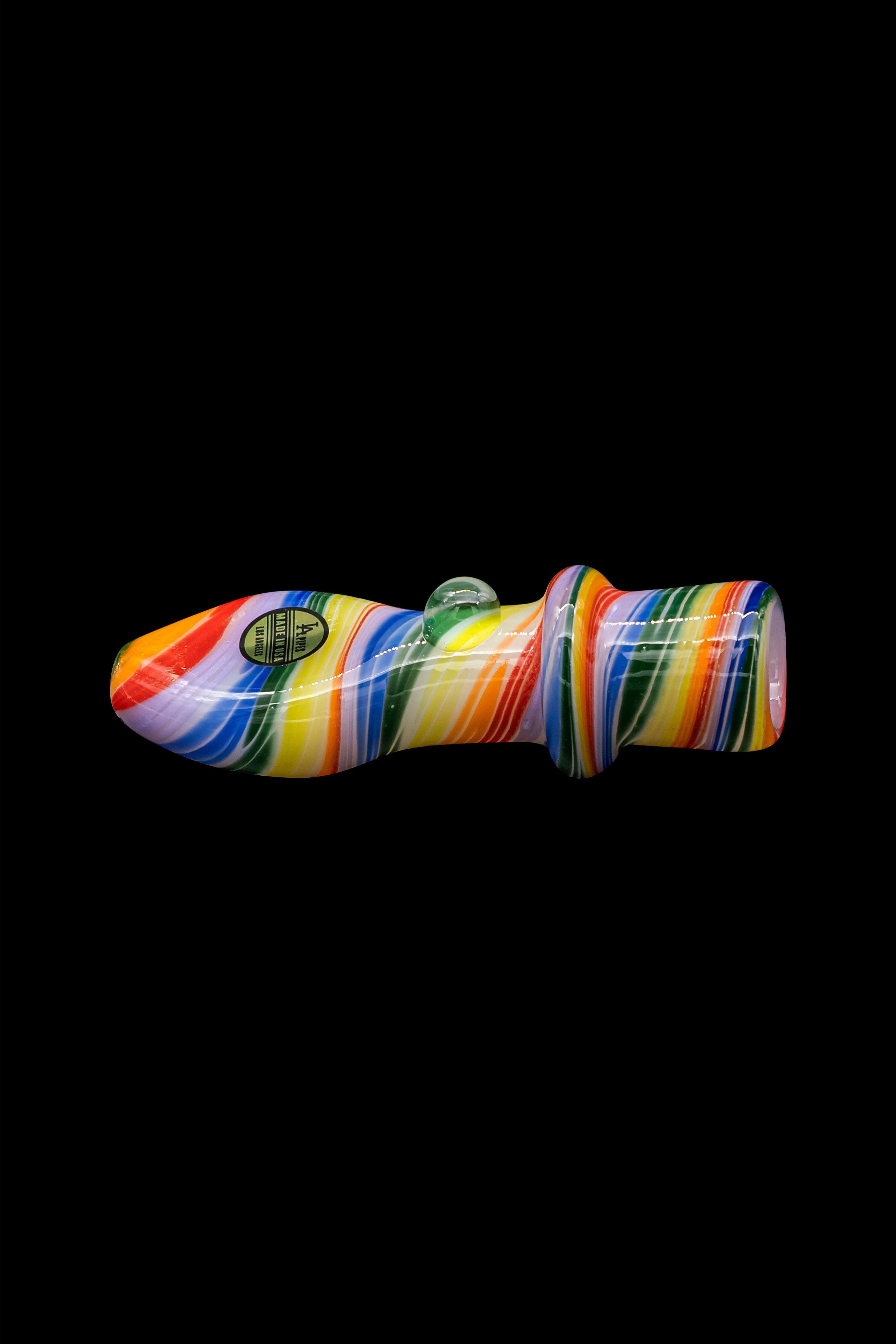 Colorful glass cannabis pipe isolated on a black background.