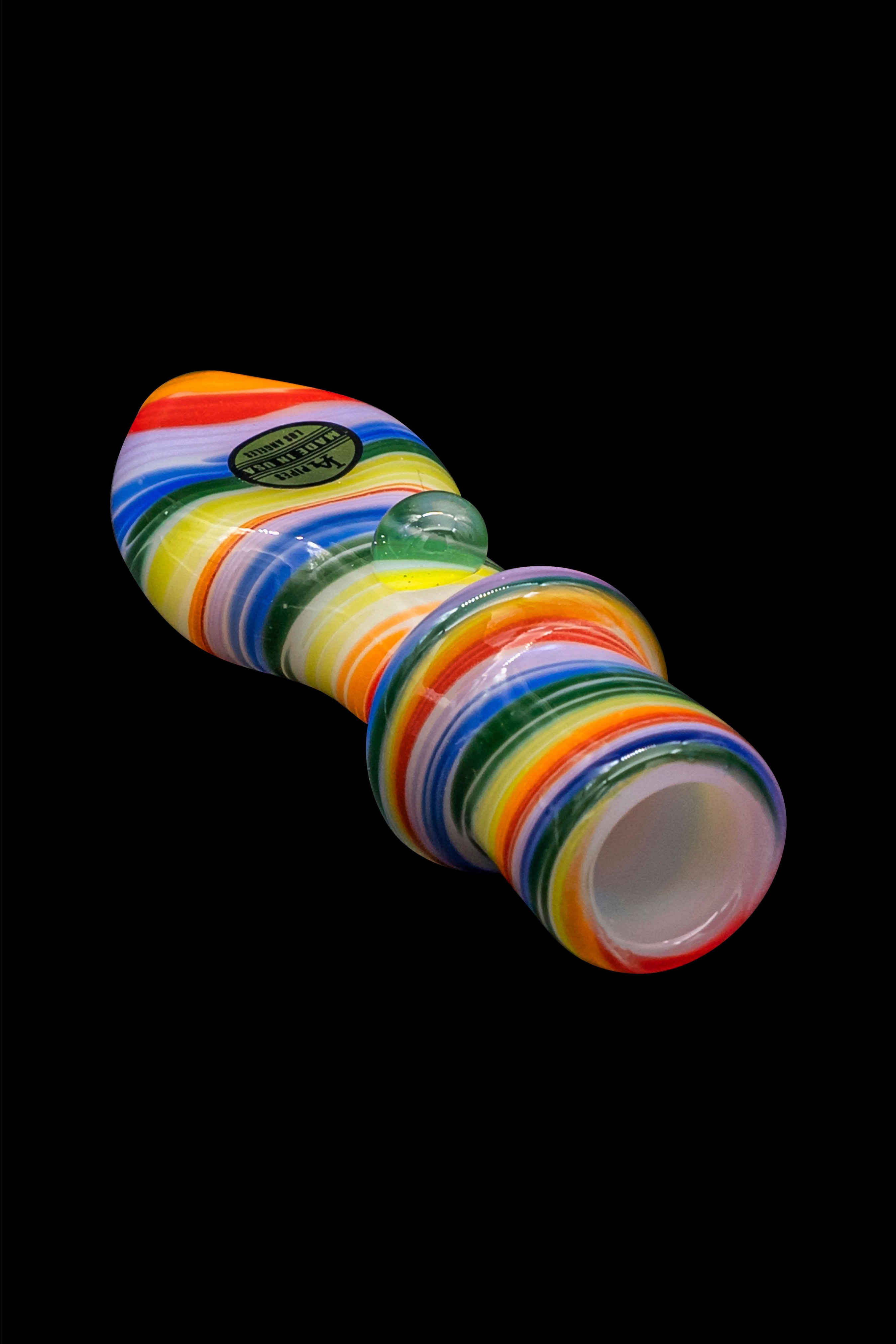 Colorful glass bubbler for smoking, isolated on a black background.