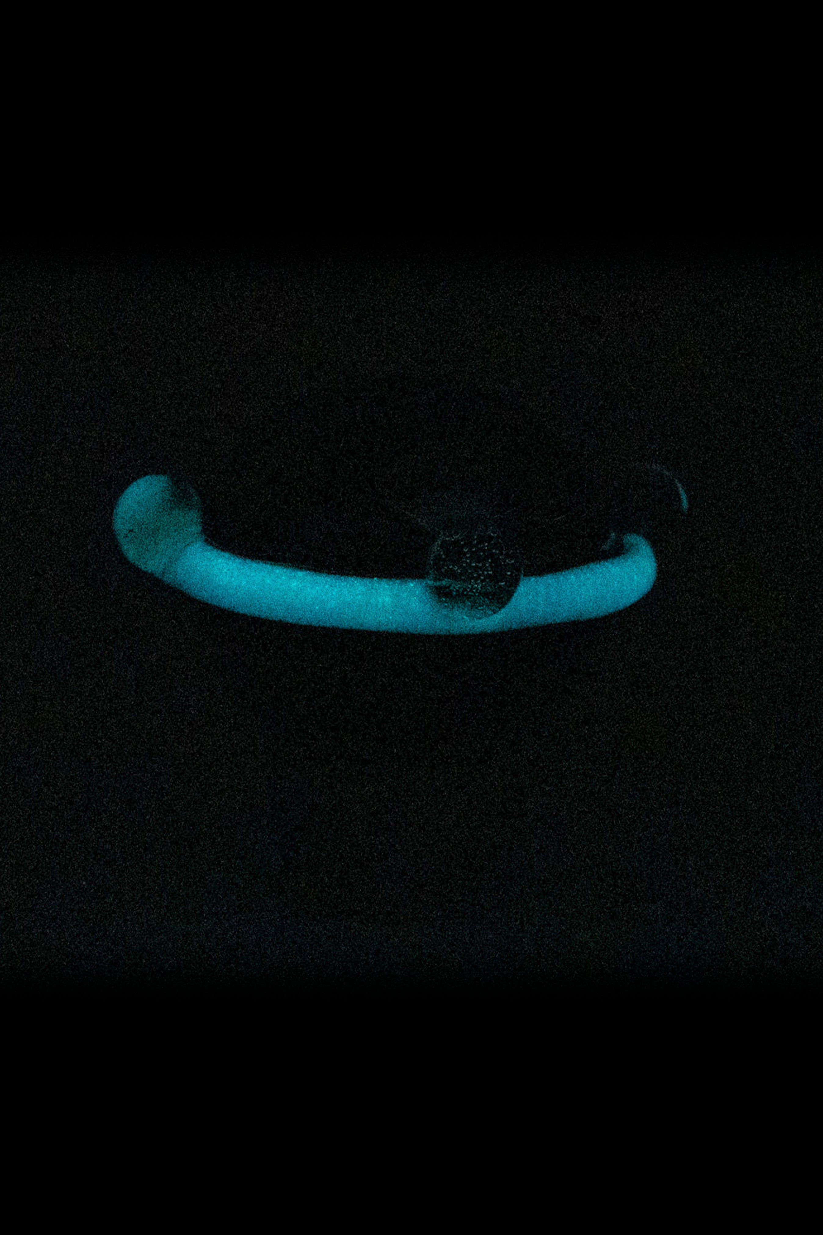 Glow-in-the-dark glass pipe with cannabis bud.