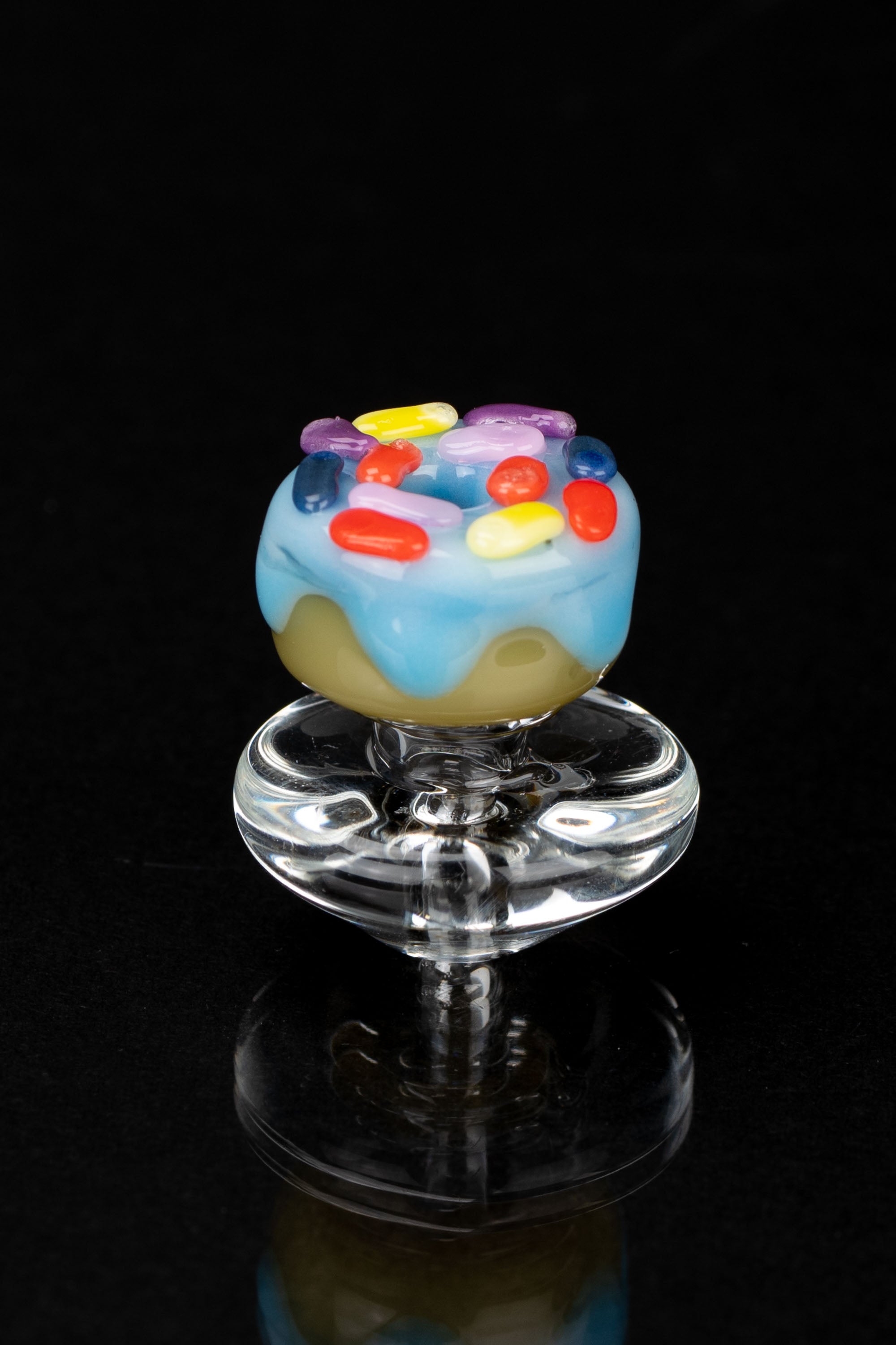 Colorful glass cannabis pipe with a whimsical, frosted donut-shaped bowl.