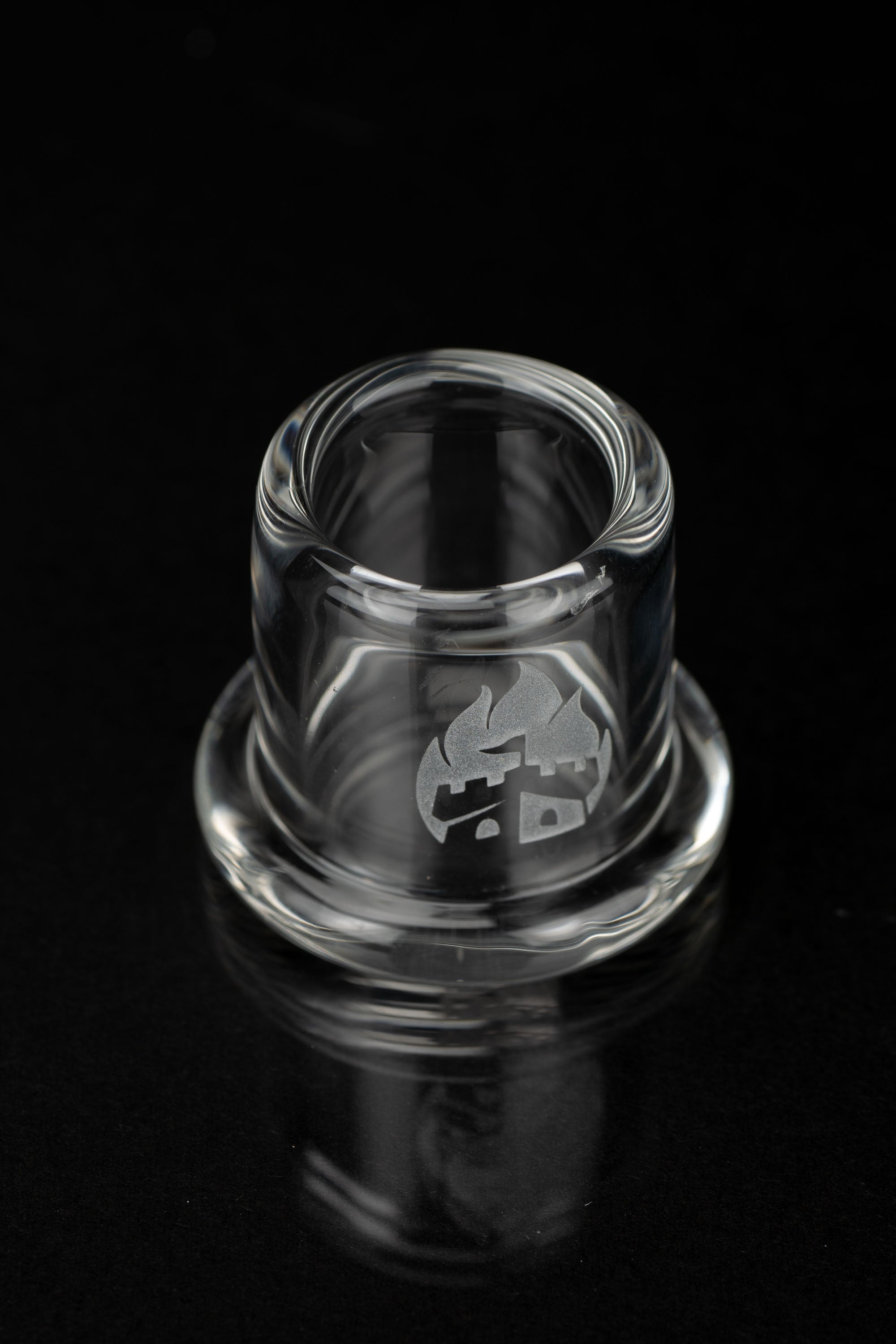 Clear glass cannabis bowl with etched logo, studio shot.