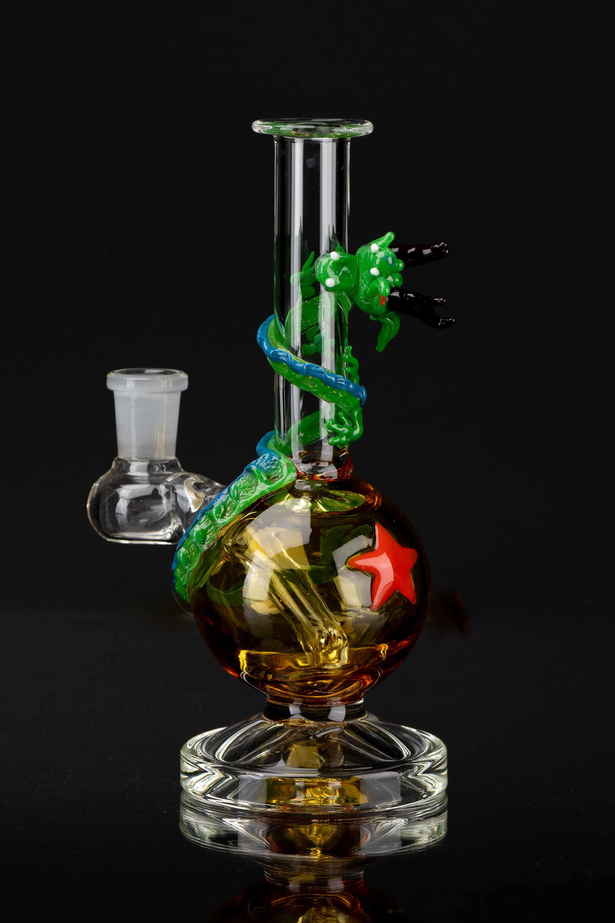 Artisan glass water pipe (bong) with vibrant green and amber detailing, featuring a sculpted dragon design.