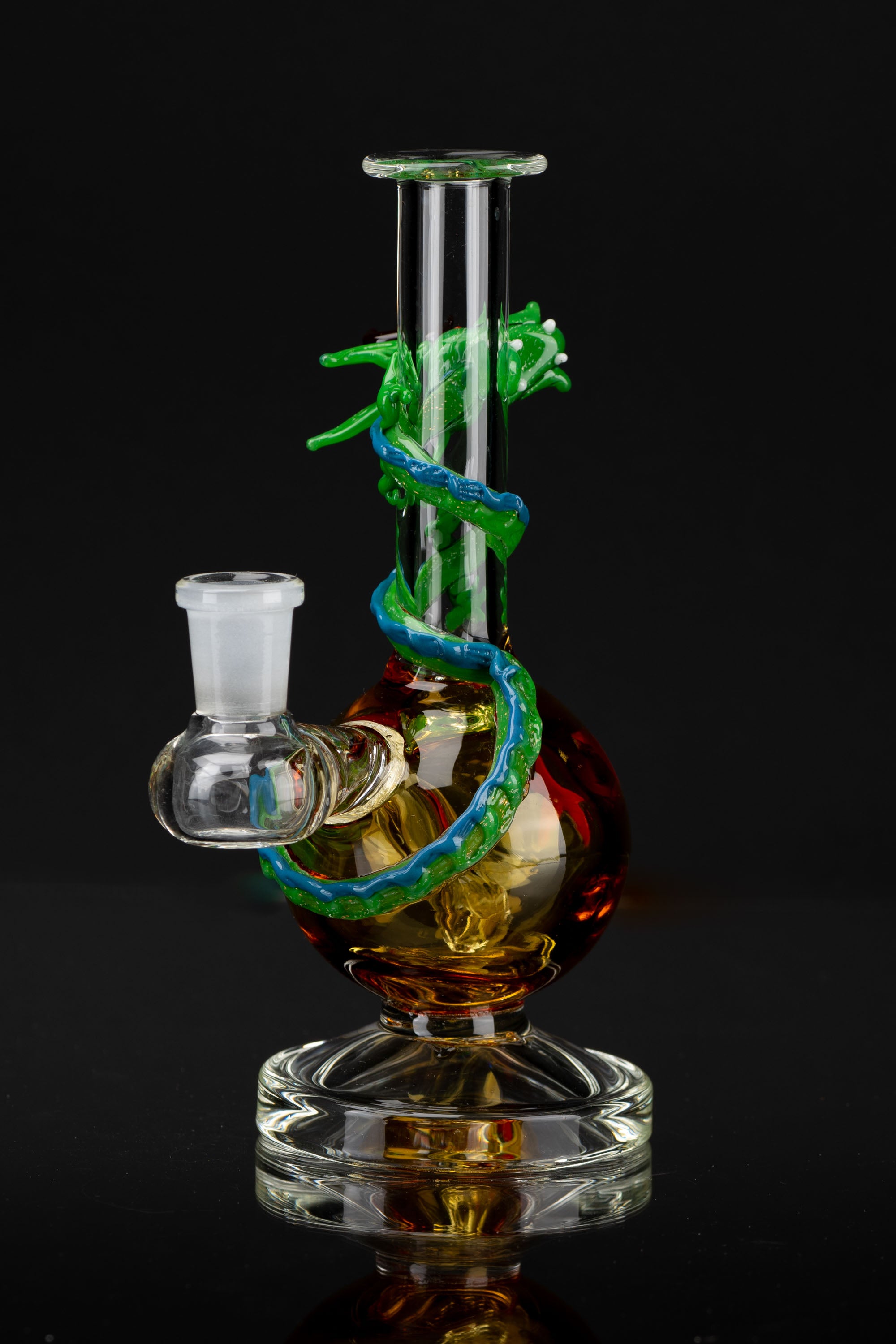A colorful glass water pipe, also known as a bong, with a serpentine design, set against a black background.
