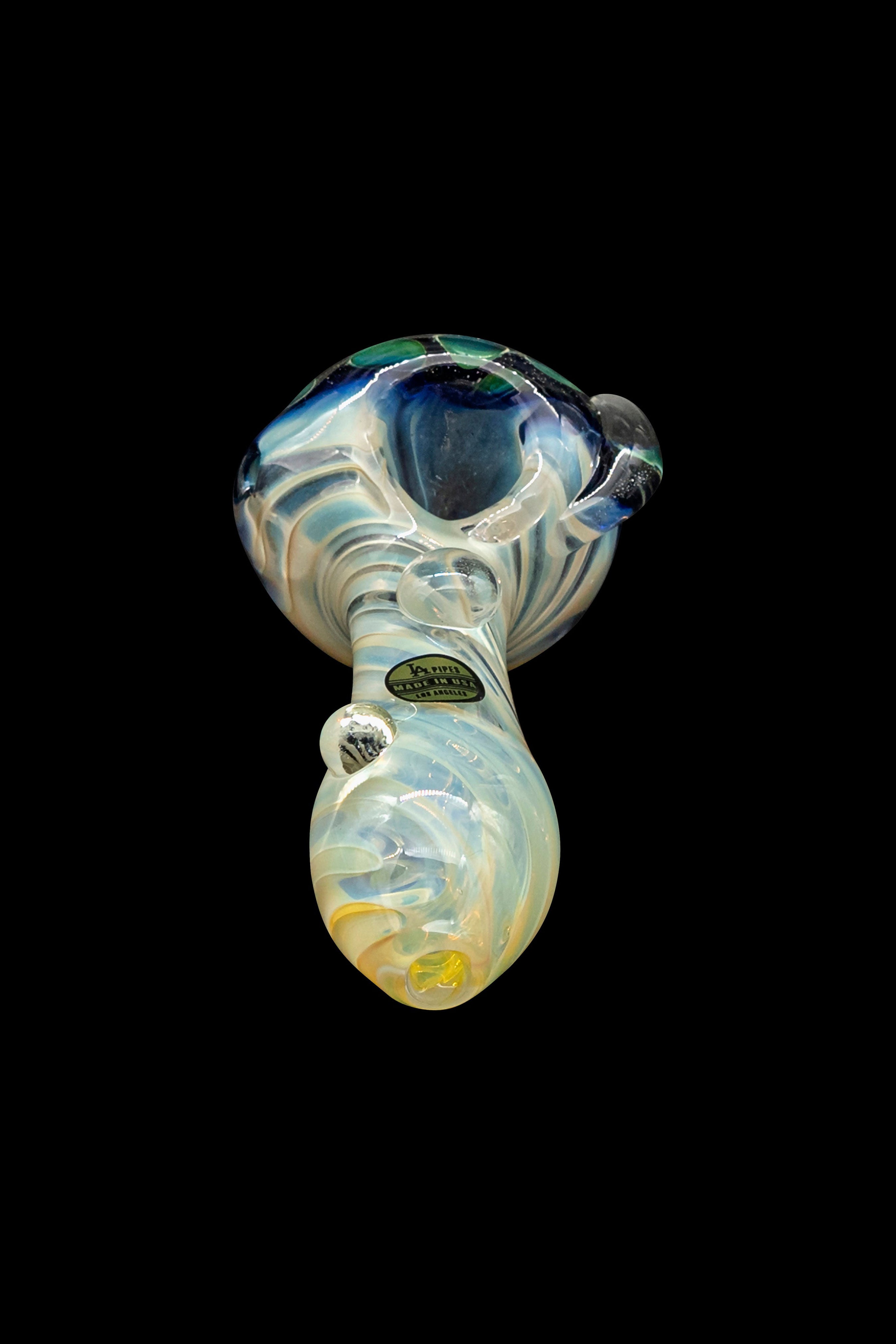 Hand-blown glass pipe with swirling blue and cream colors.