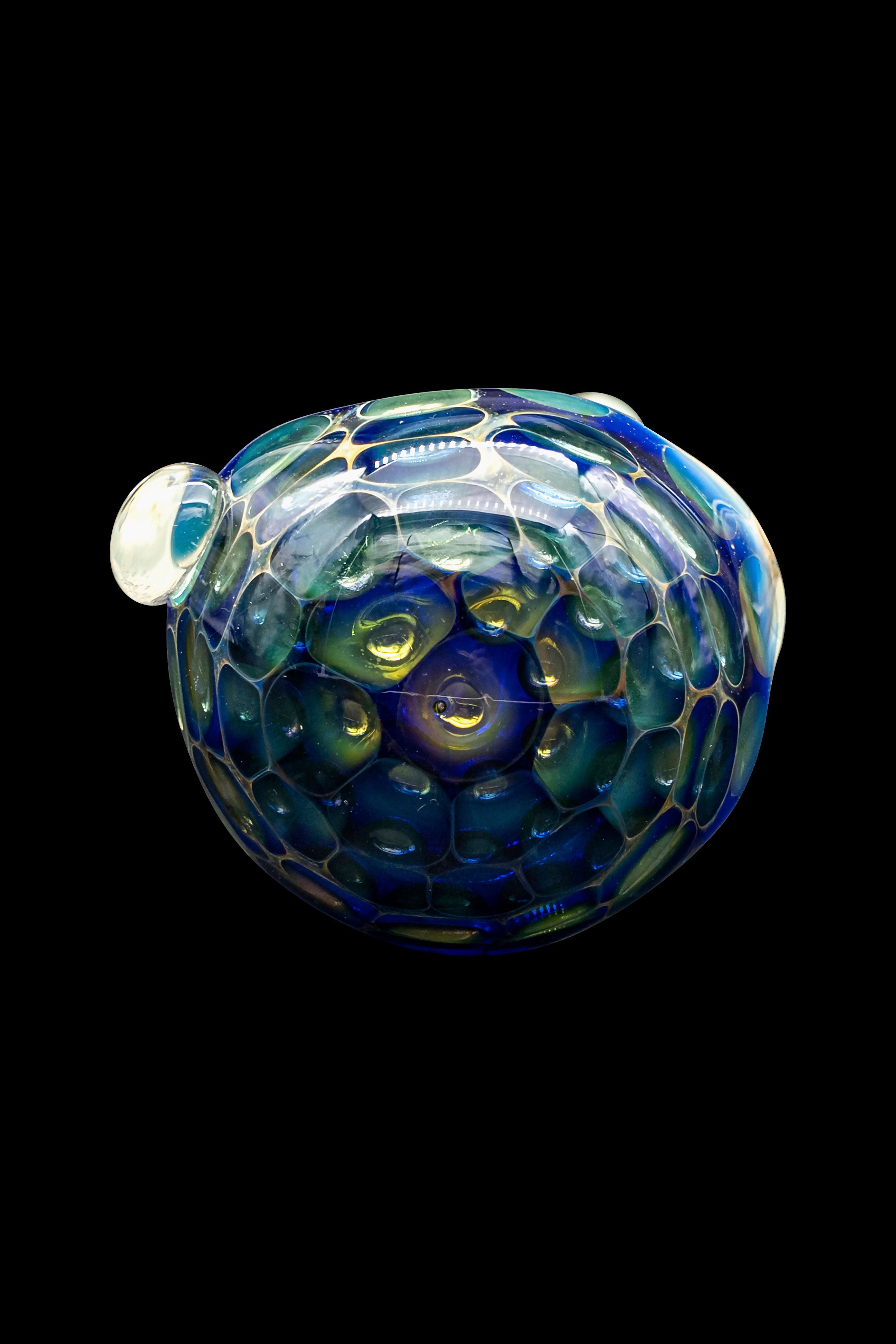 Iridescent glass cannabis water pipe against a black background.