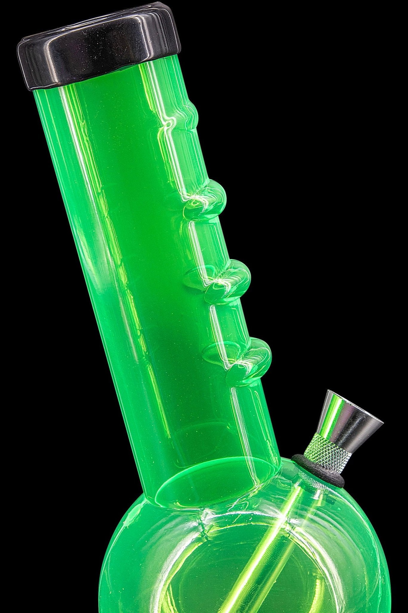 Green glass bong with bubbling water visible inside, against a black background.