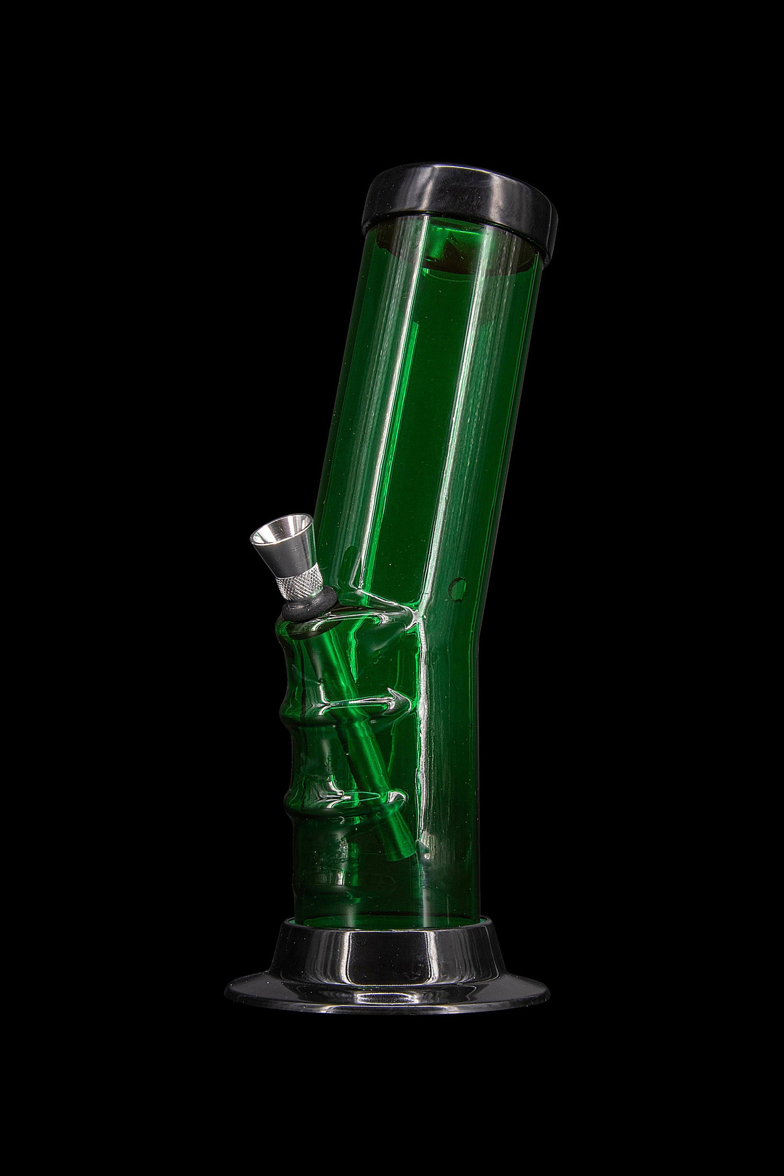 Green glass water pipe (bong) against a black background.