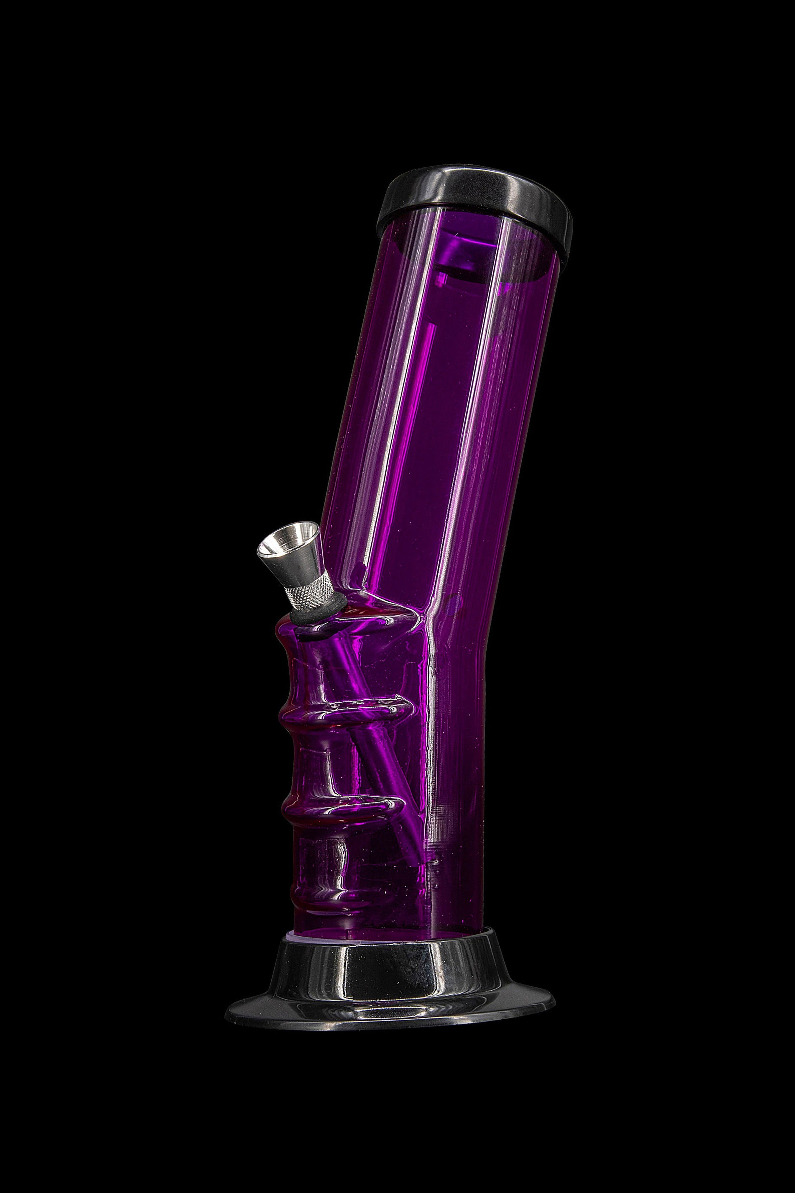 Purple glass bong with metal downstem against a black background.