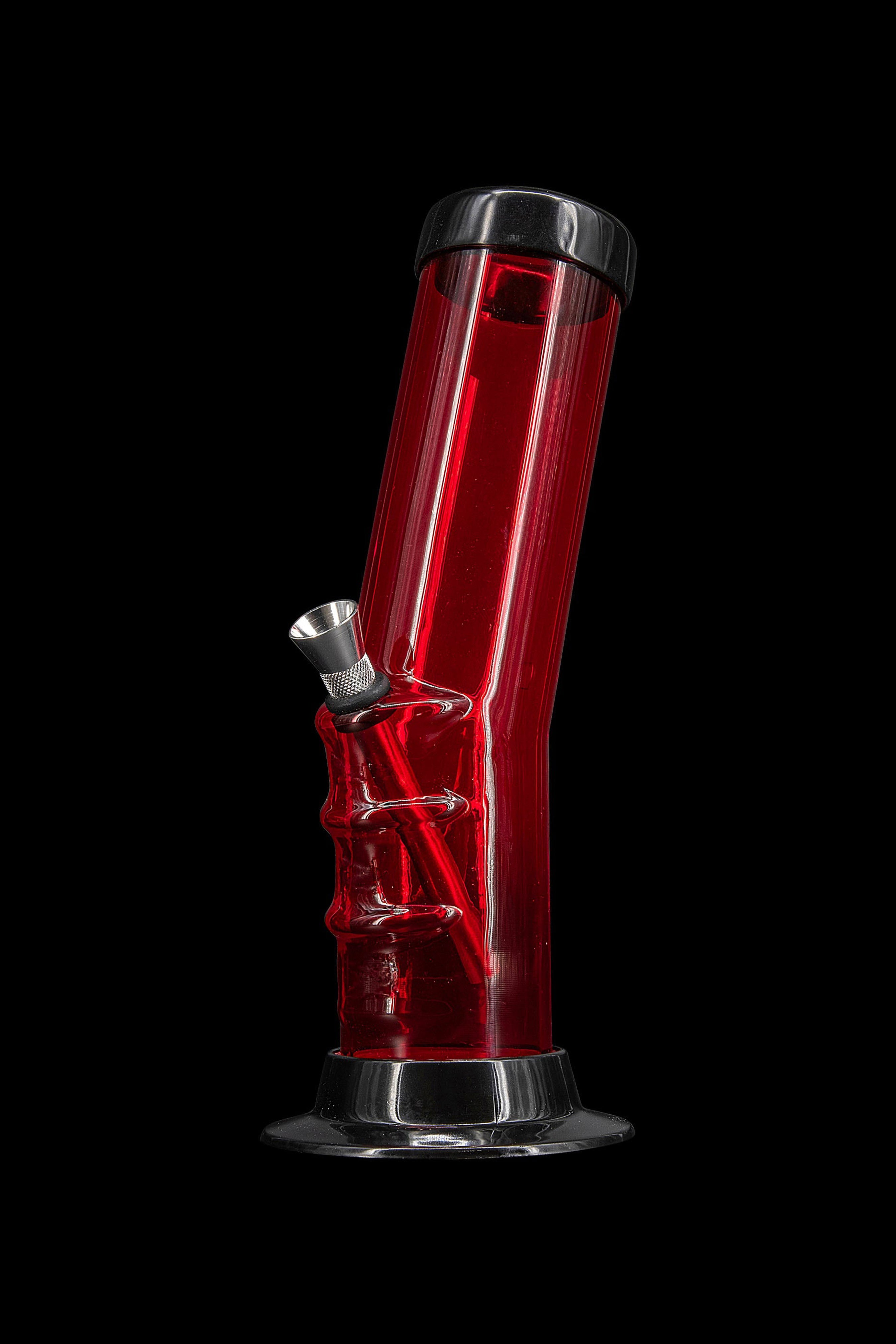 Red glass water pipe with metallic accents against a black background.