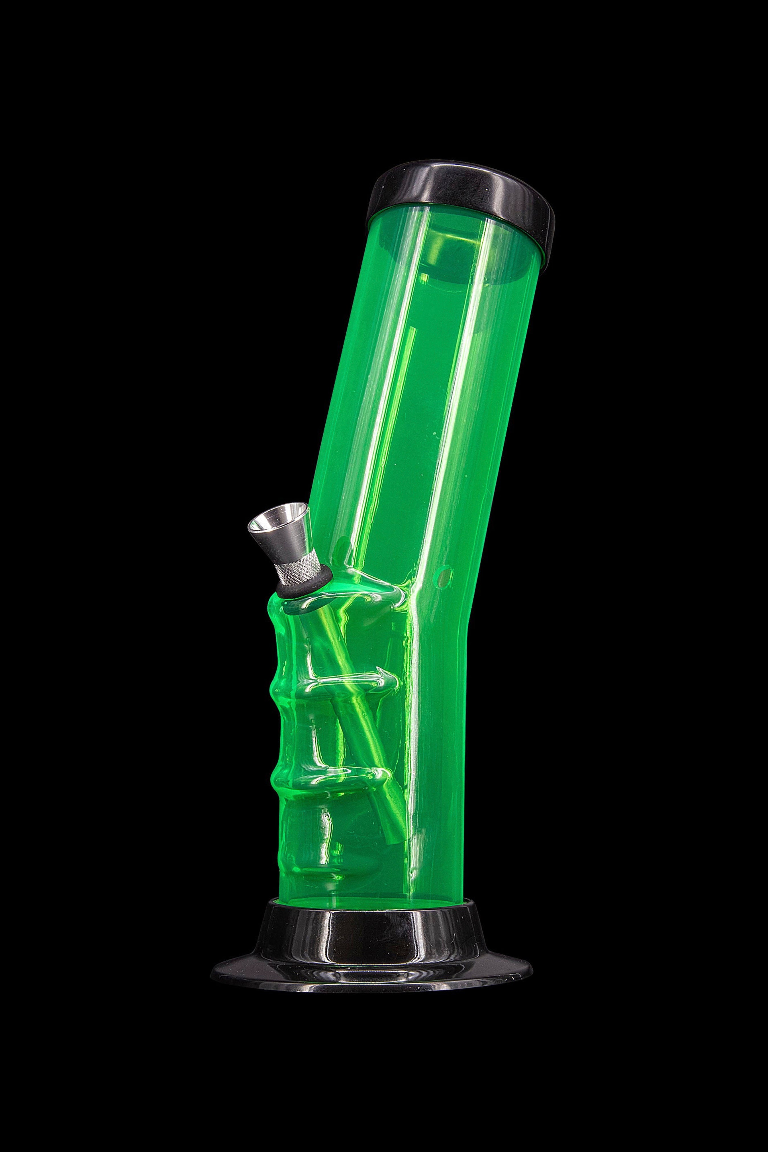 Green glass water pipe (bong) with a metal bowl, isolated on a black background.