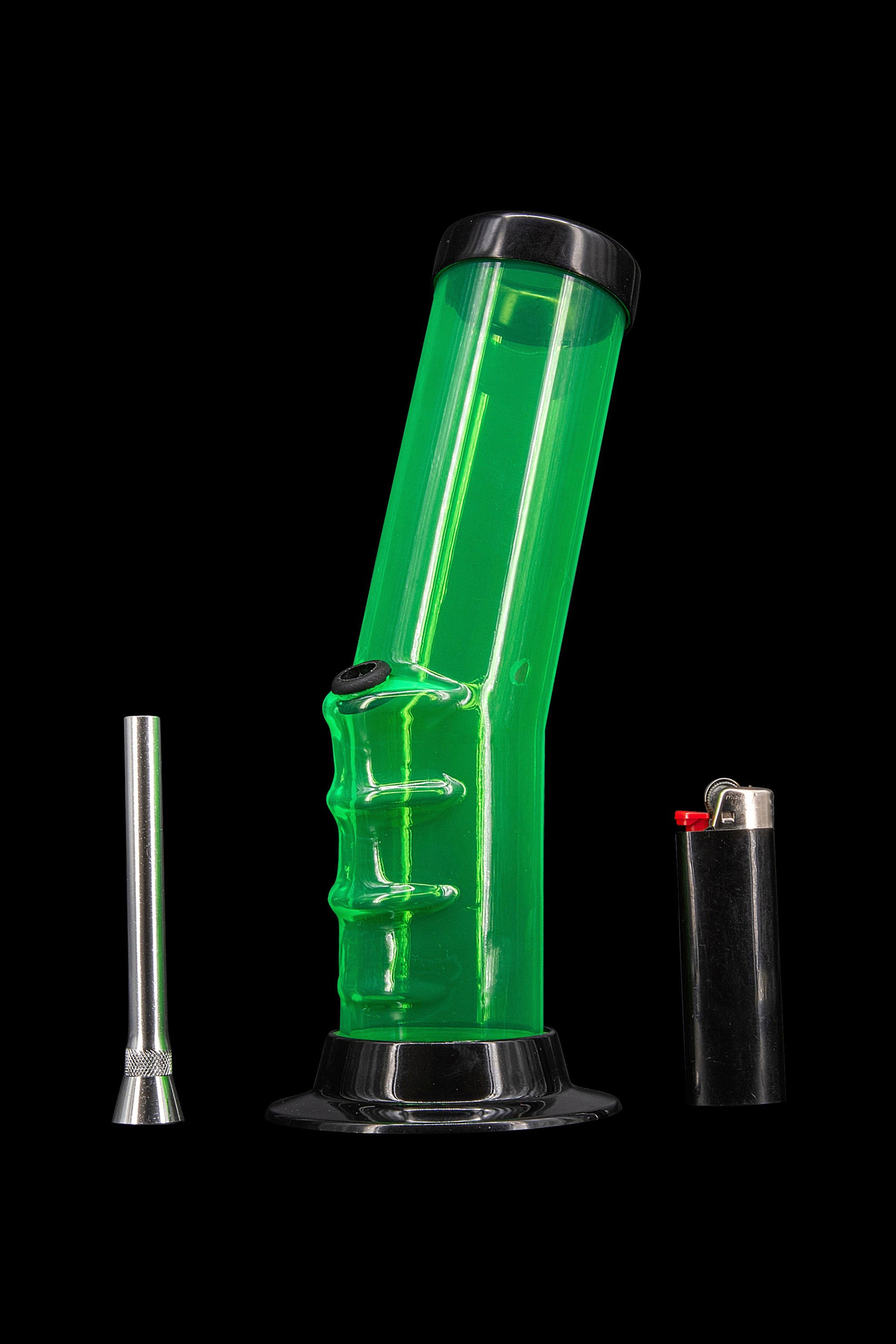 Green glass water pipe with metal downstem and lighter on a black background.